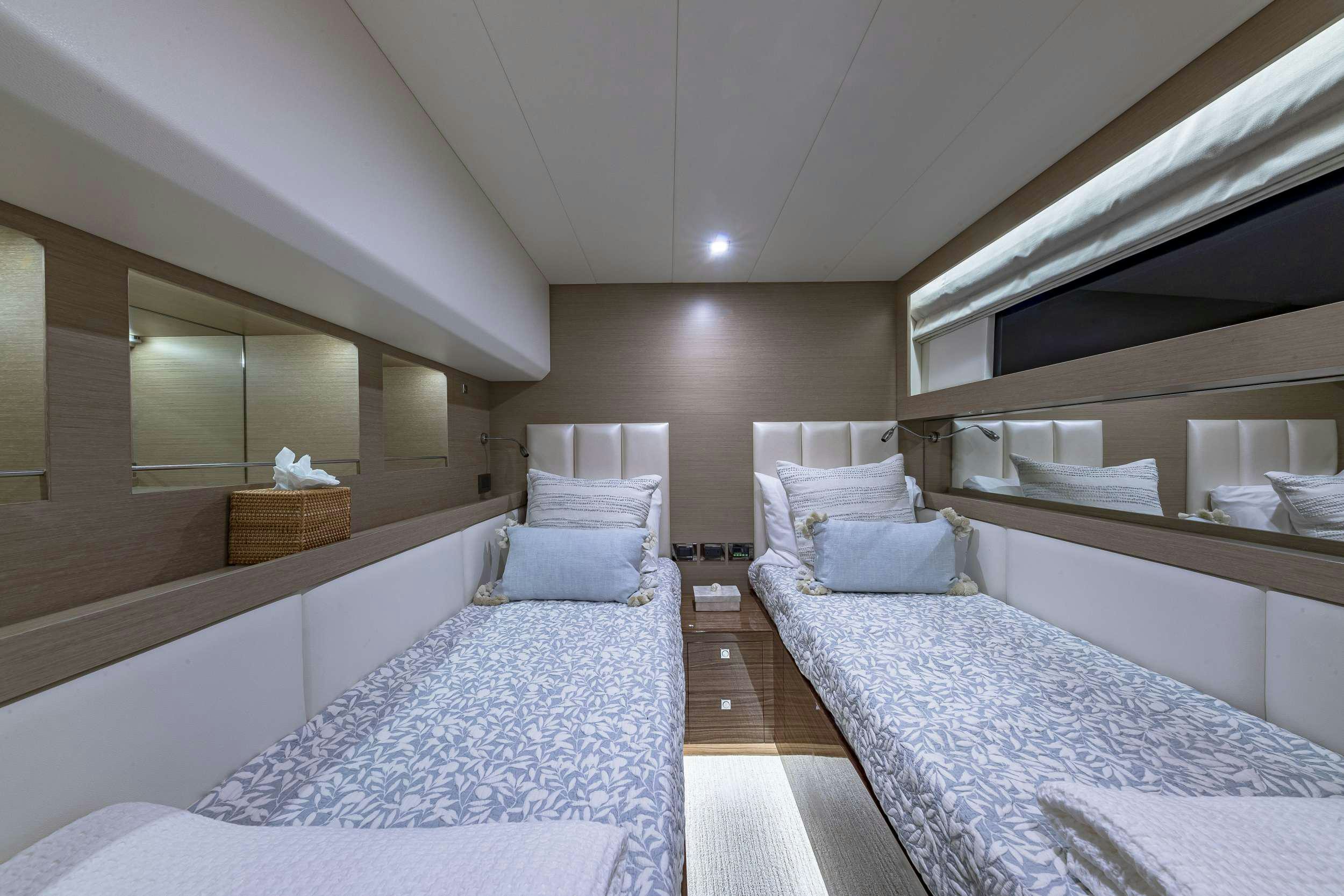 a room with two beds aboard OMAKASE Yacht for Charter