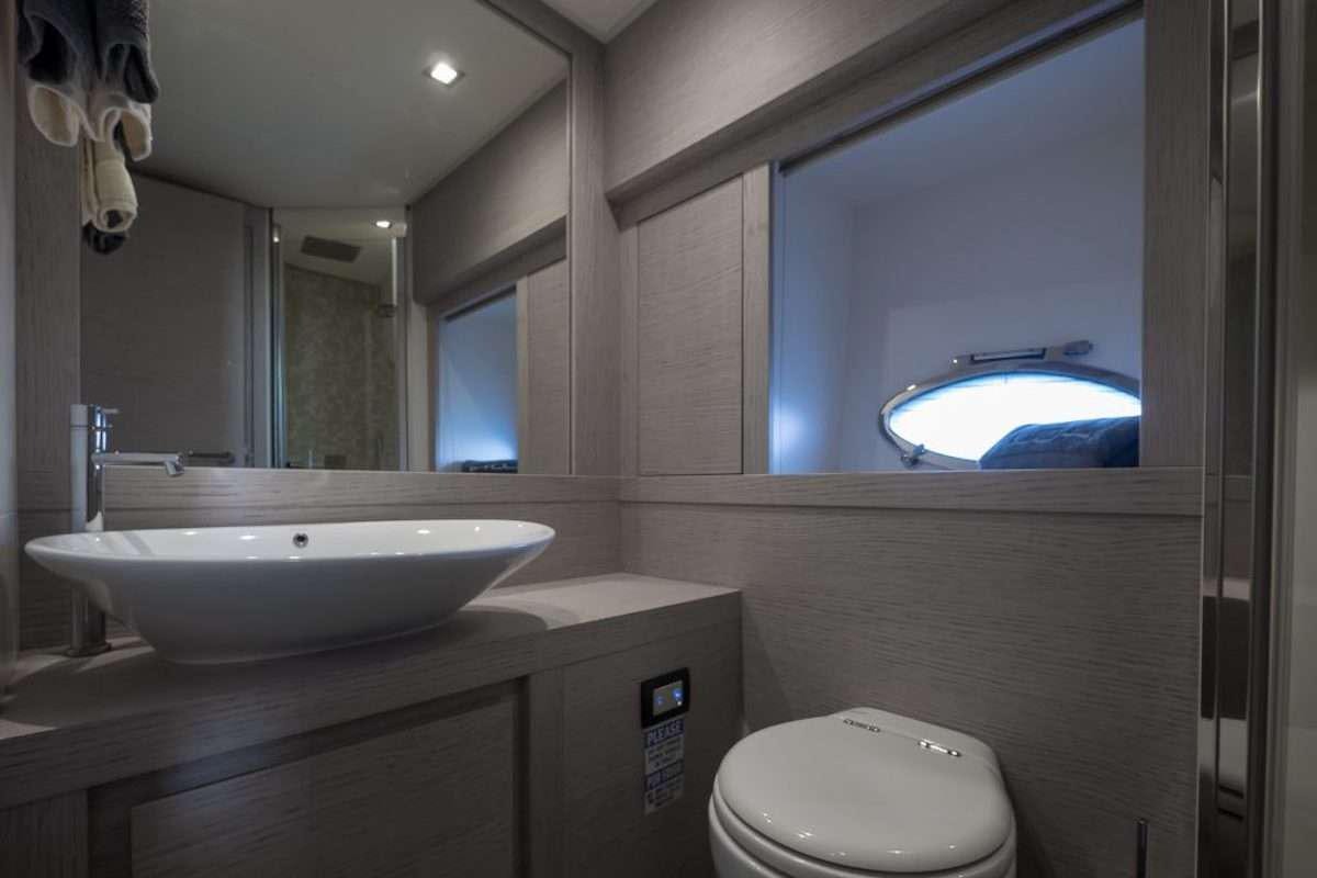 a bathroom with a large mirror aboard LOKI Yacht for Charter