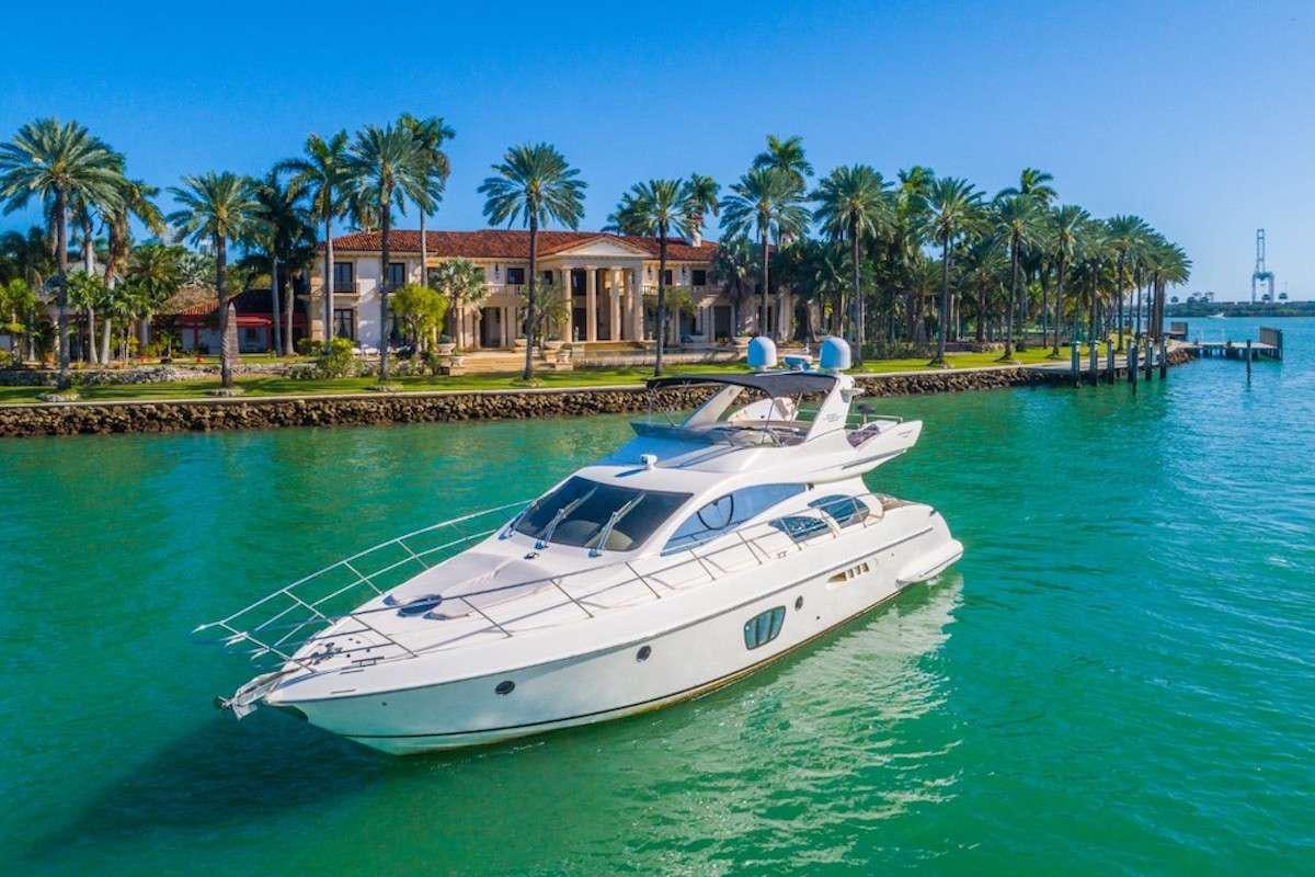 a white boat in the water aboard KOWBOY BABY Yacht for Charter