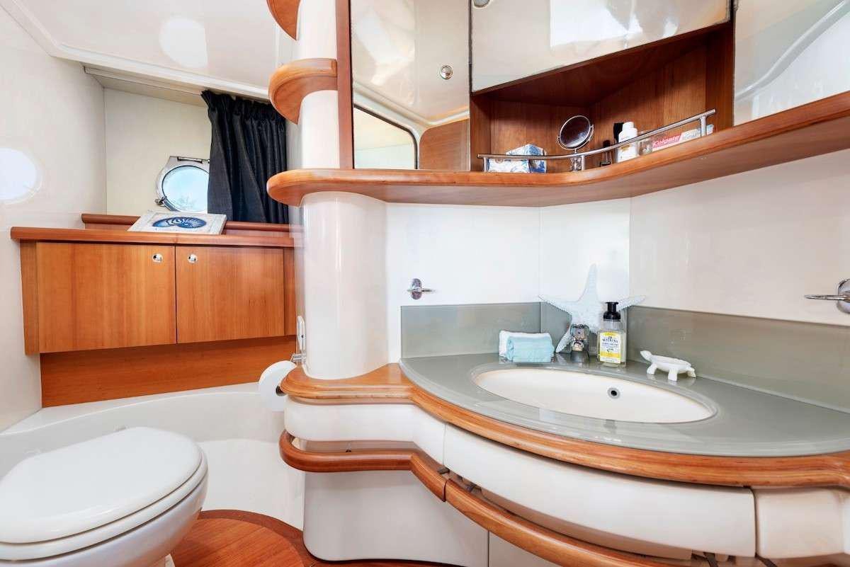 a bathroom with a sink and a toilet aboard KOWBOY BABY Yacht for Charter