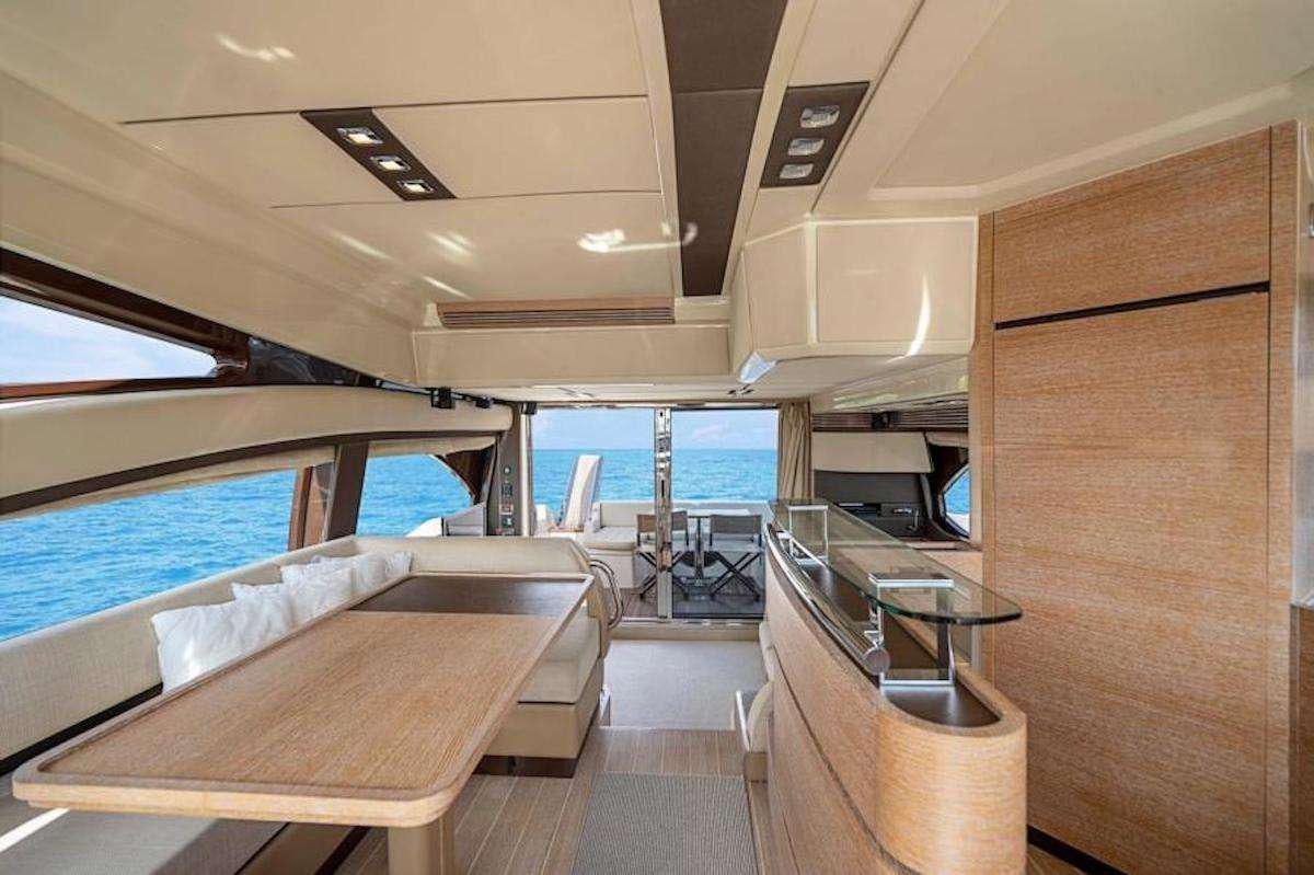 a room with a bed and a table and chairs aboard BLUE SEA Yacht for Charter