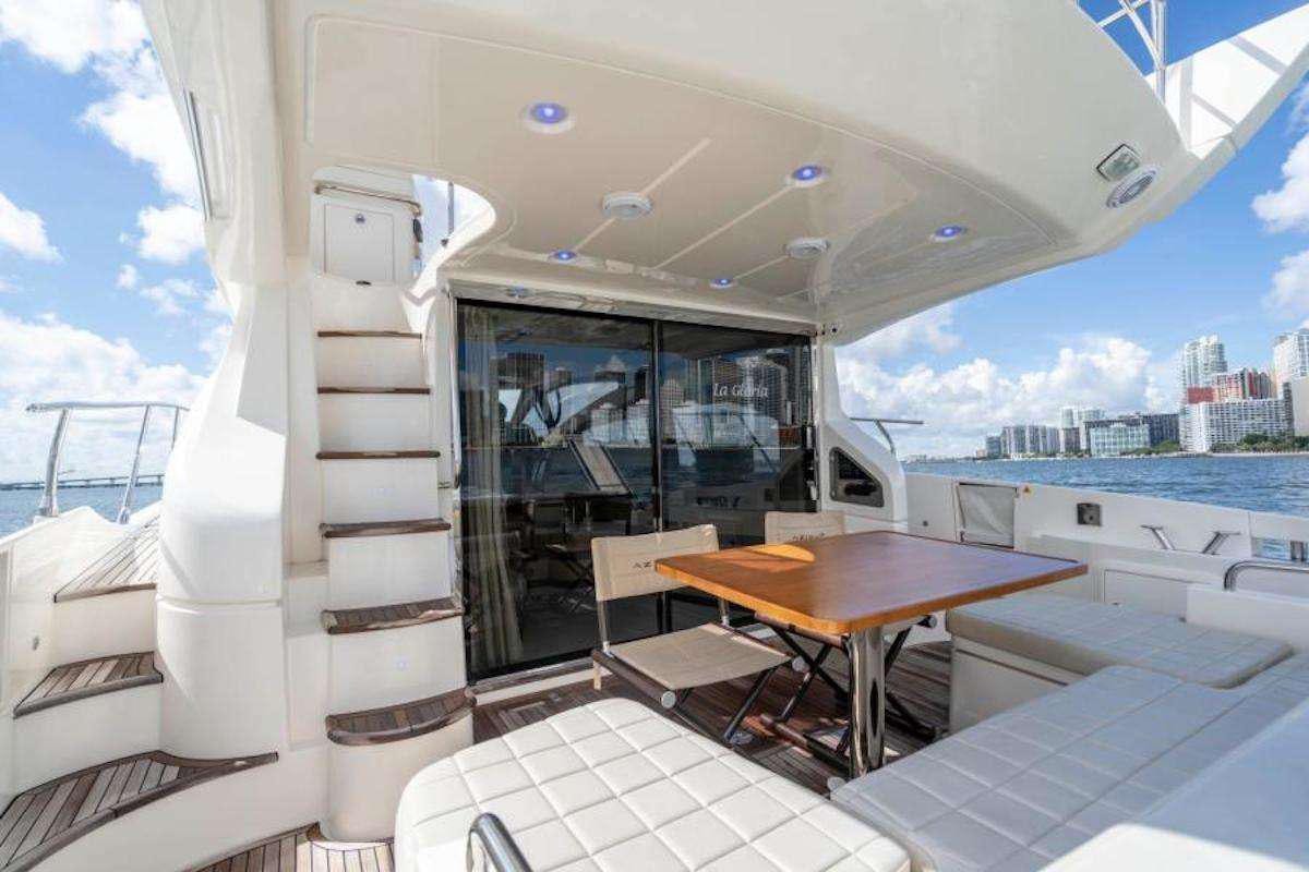 a boat with a table and chairs aboard BLUE SEA Yacht for Charter