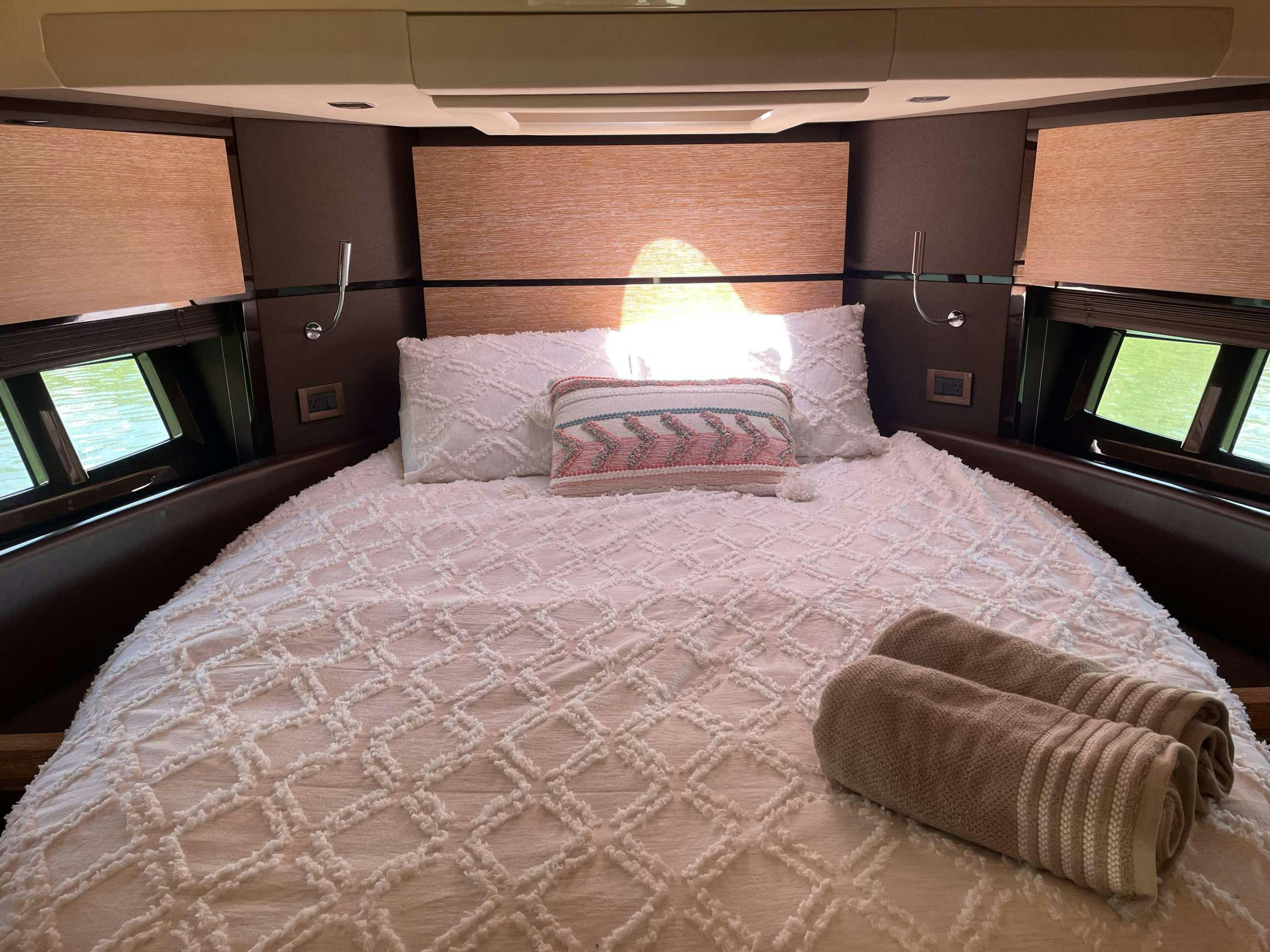 a bed with white sheets aboard BLUE SEA Yacht for Charter