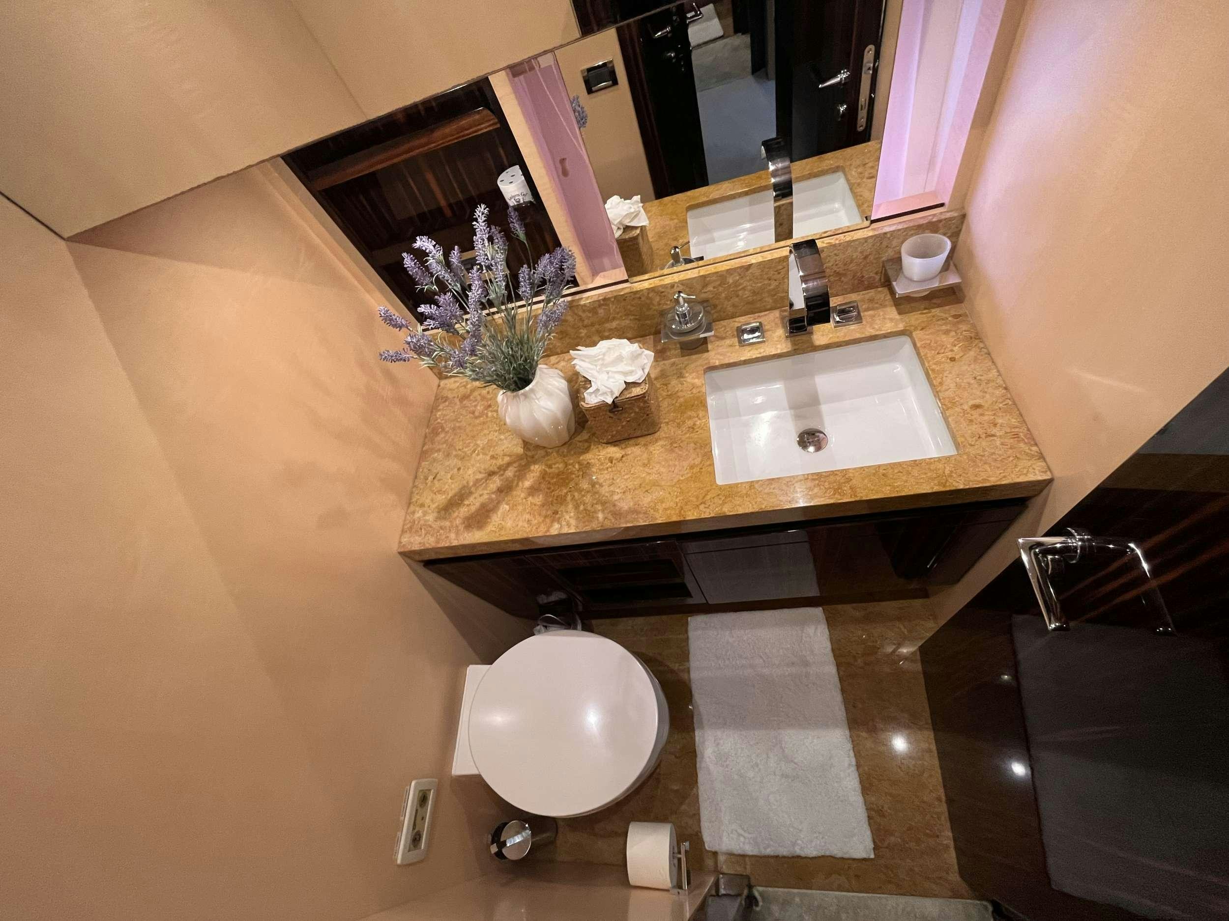 a bathroom with a sink and mirror aboard 86  ITALIAN Yacht for Charter