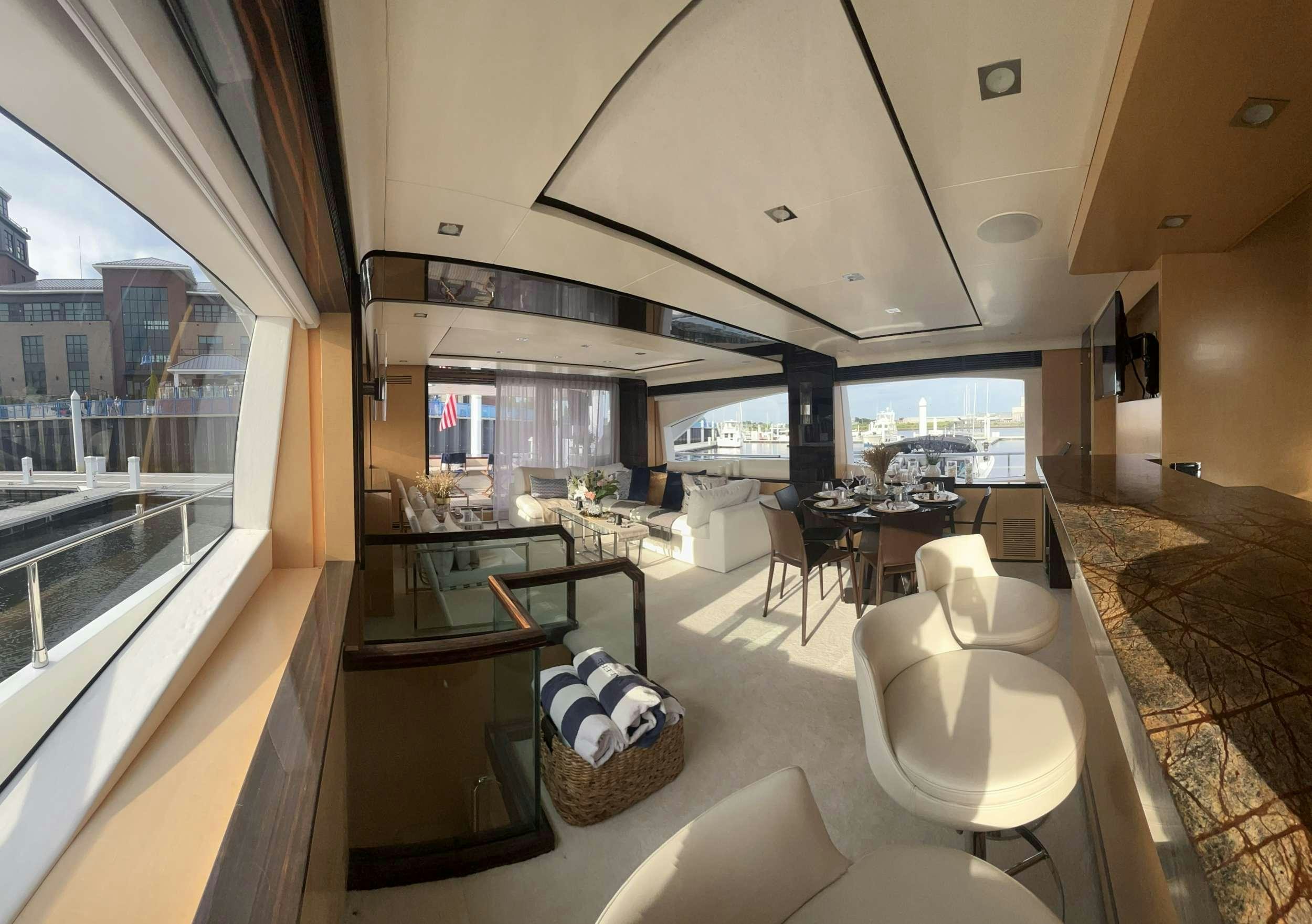 a room with a table chairs and a large window aboard 86  ITALIAN Yacht for Charter