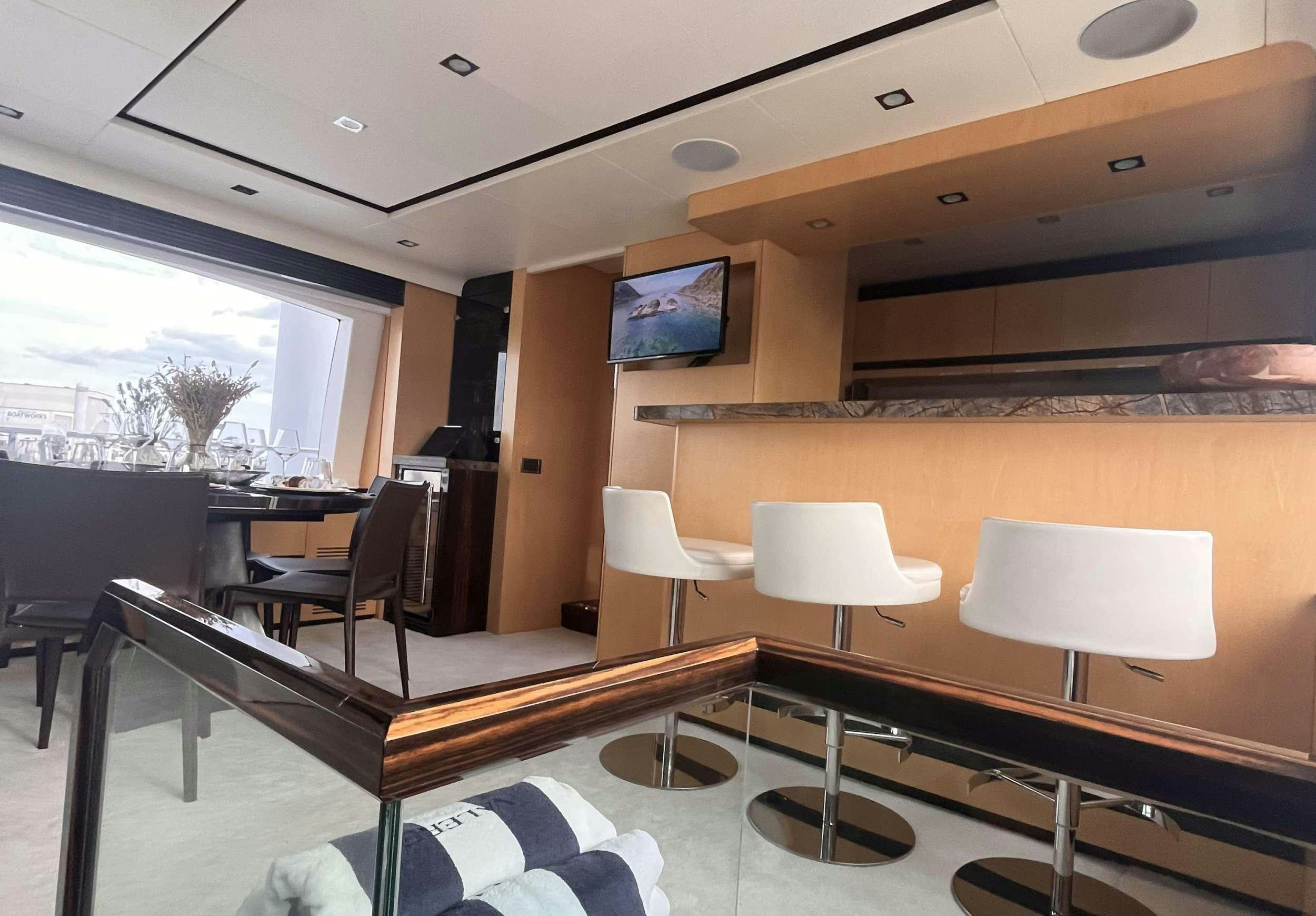 a room with a table and chairs aboard 86  ITALIAN Yacht for Charter