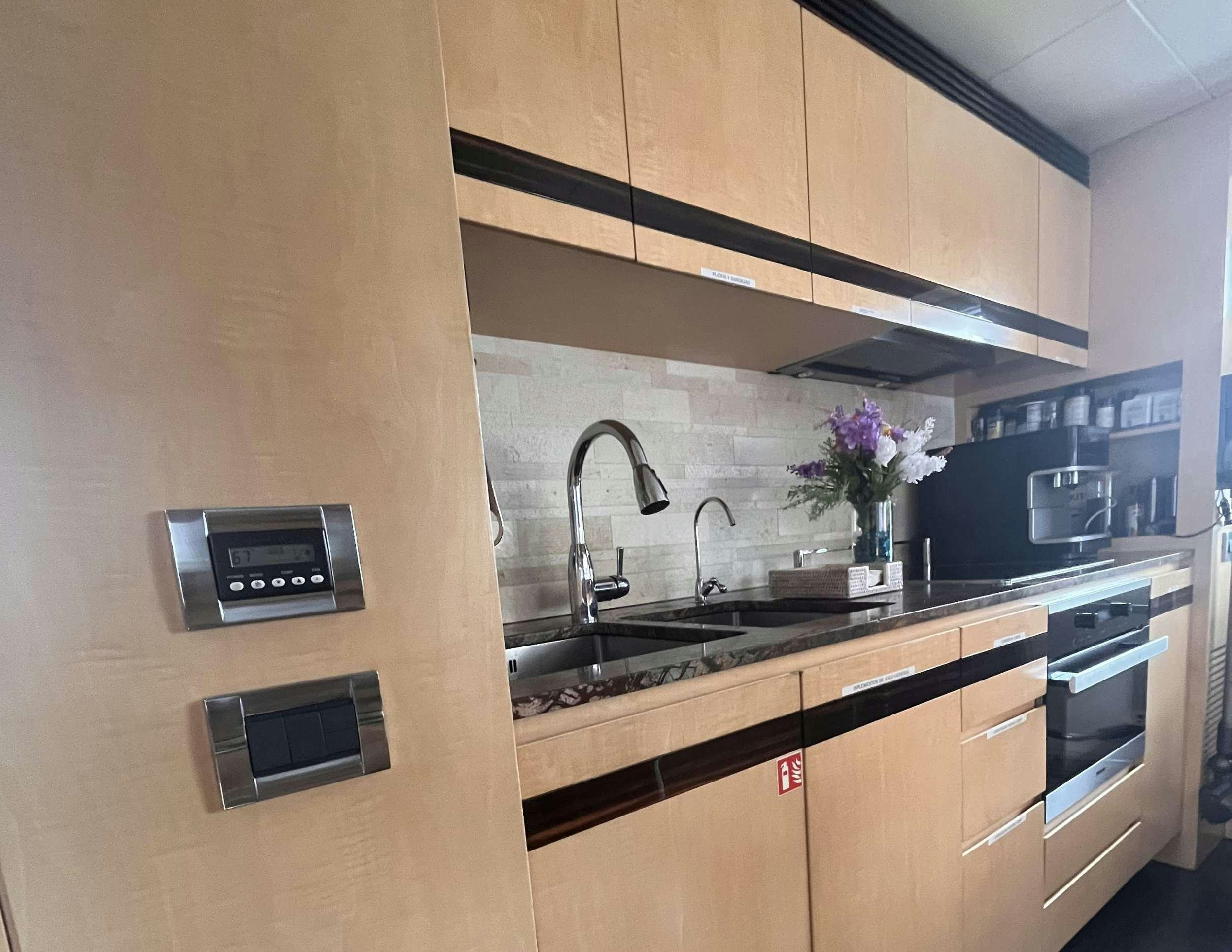 a kitchen with wooden cabinets aboard 86  ITALIAN Yacht for Charter