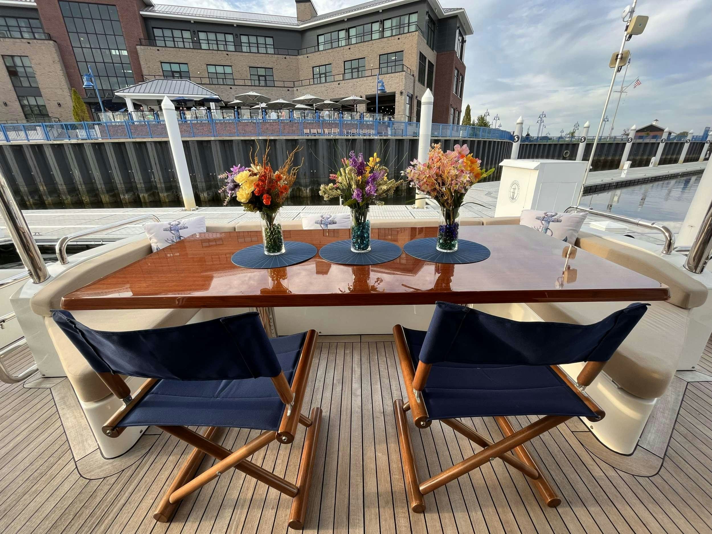 a table with chairs on it aboard 86  ITALIAN Yacht for Charter
