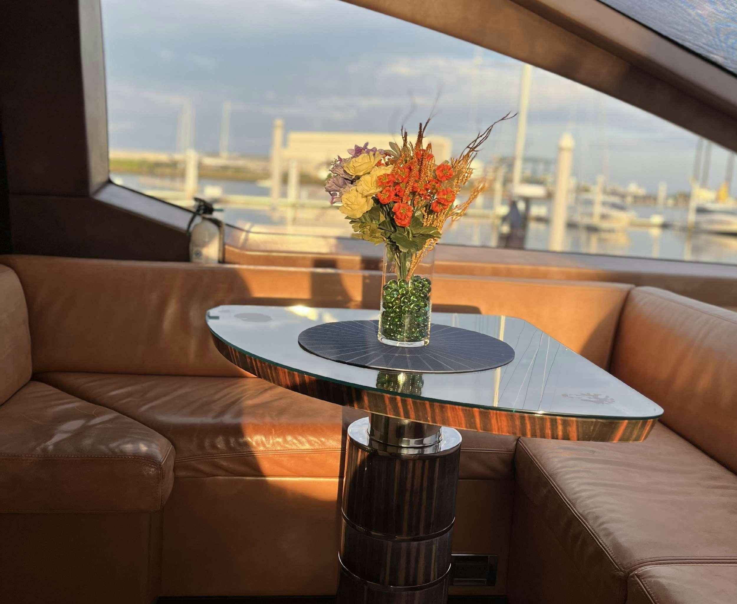 a vase of flowers on a table aboard 86  ITALIAN Yacht for Charter