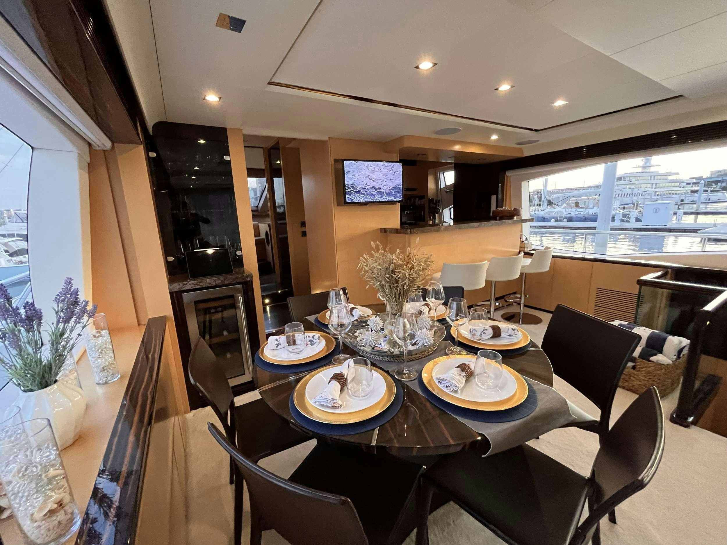 a dining room with a table and chairs aboard 86  ITALIAN Yacht for Charter