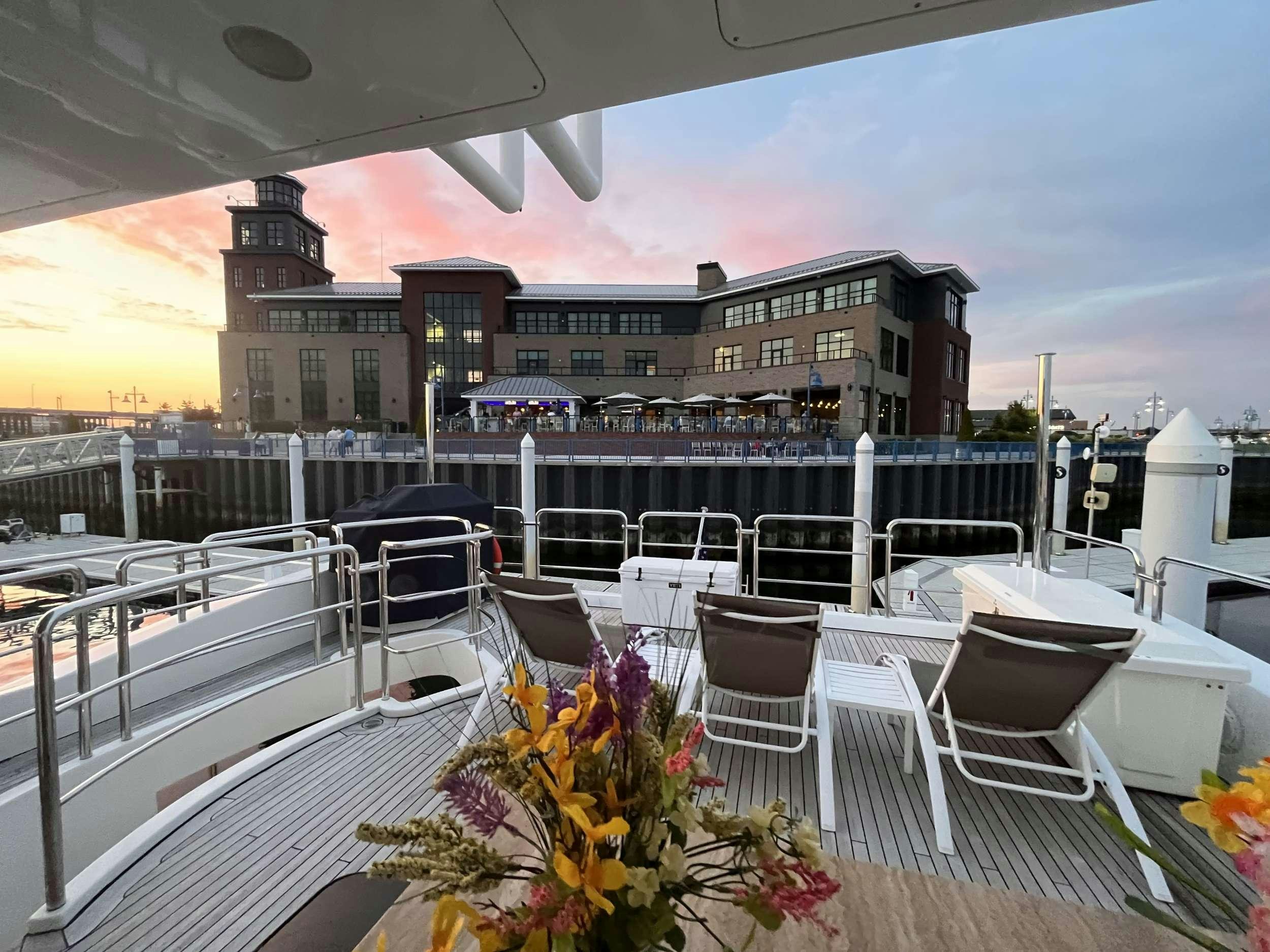 a patio with tables and chairs aboard 86  ITALIAN Yacht for Charter