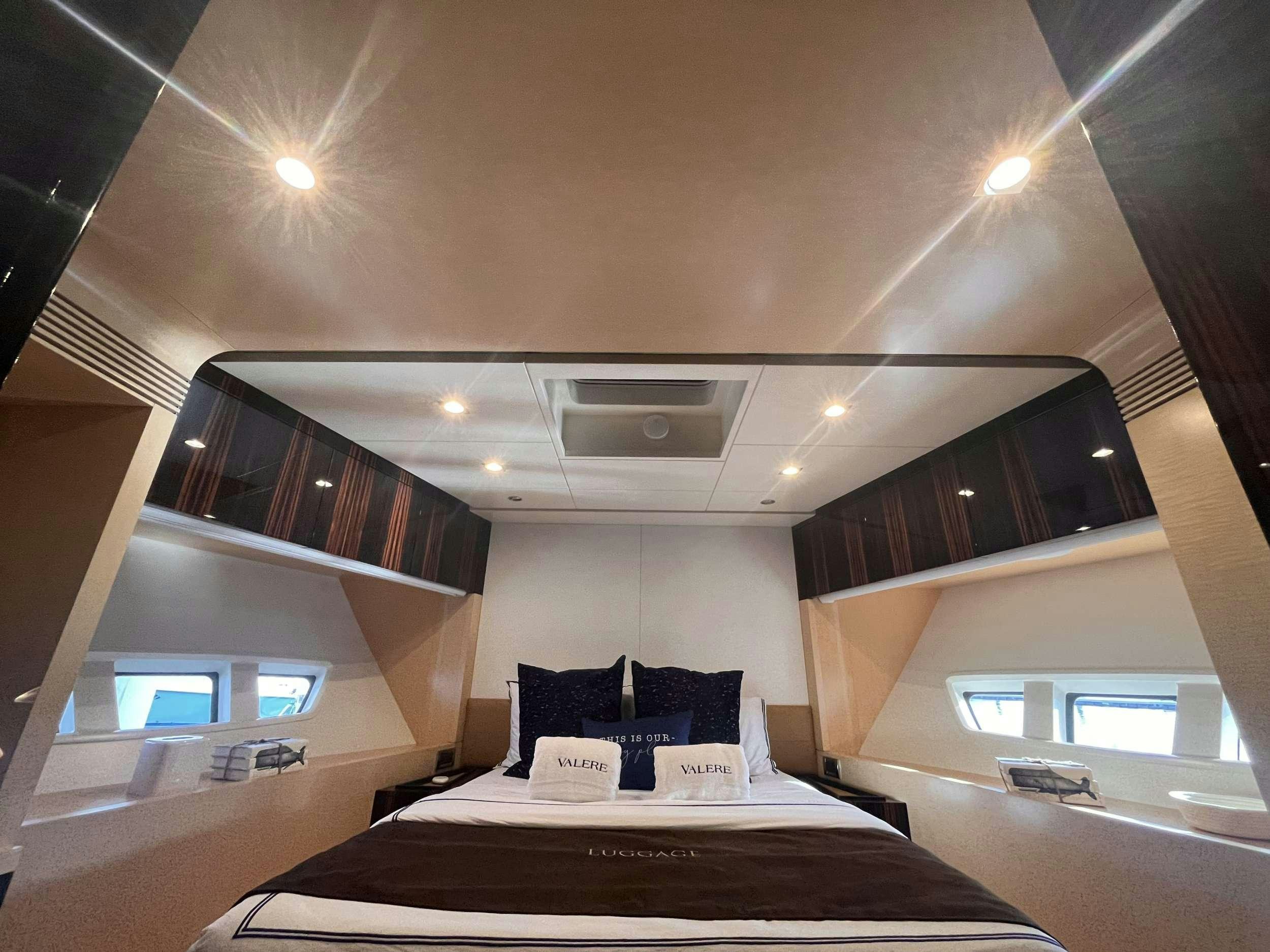 a bedroom with a bed and a large window aboard 86  ITALIAN Yacht for Charter