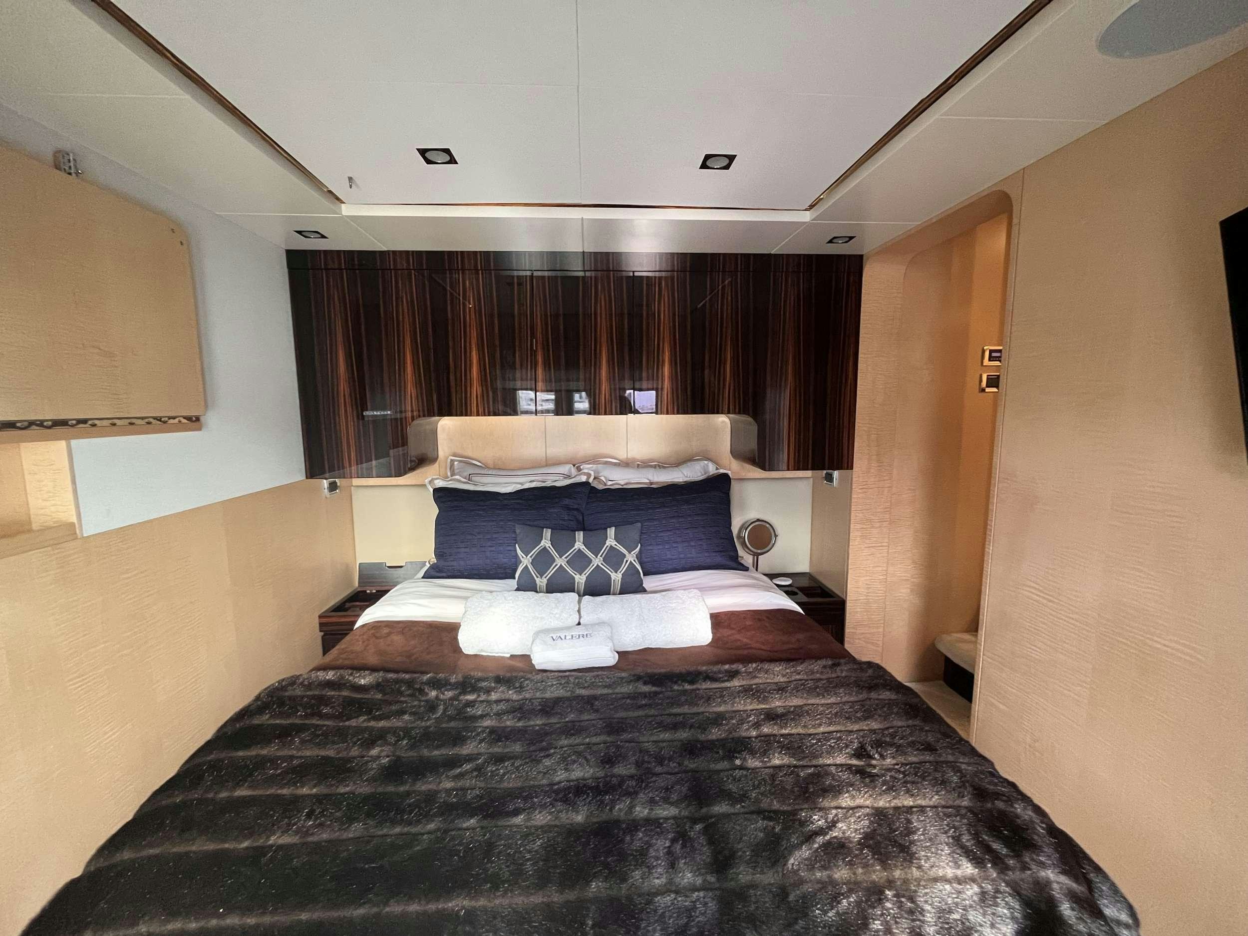 a bed with a black bed spread aboard 86  ITALIAN Yacht for Charter