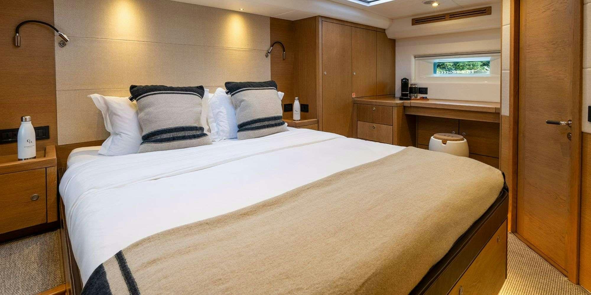 a bed with white sheets aboard CHAMPAGNE HIPPY Yacht for Charter