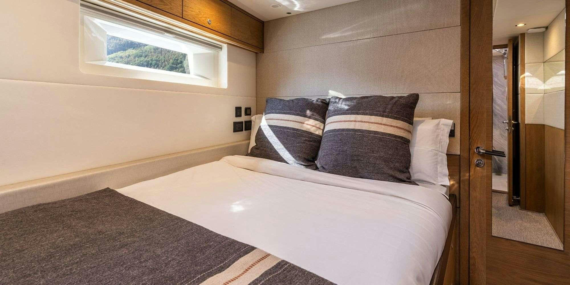 a bed with pillows aboard CHAMPAGNE HIPPY Yacht for Charter