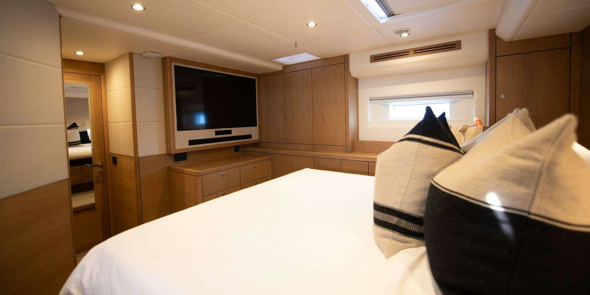 a room with a tv and a couch aboard CHAMPAGNE HIPPY Yacht for Charter