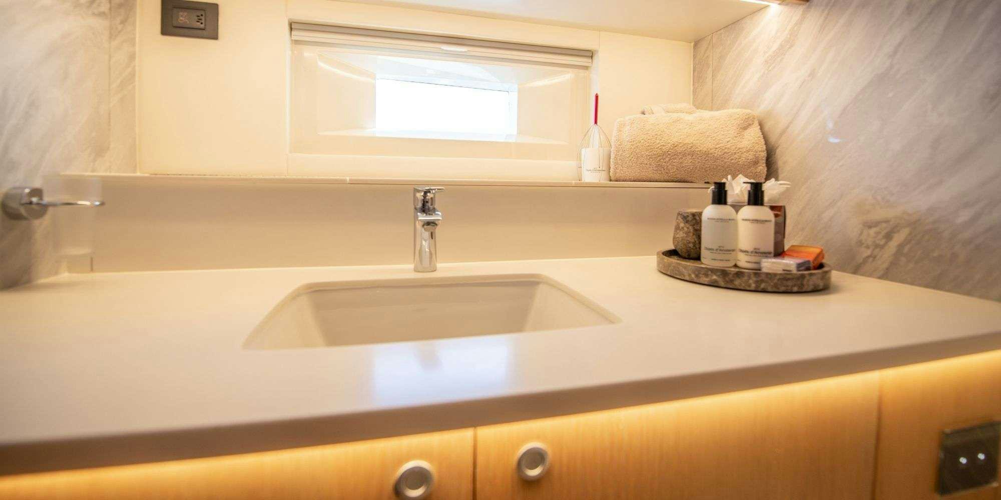 a bathroom sink with a mirror above it aboard CHAMPAGNE HIPPY Yacht for Charter