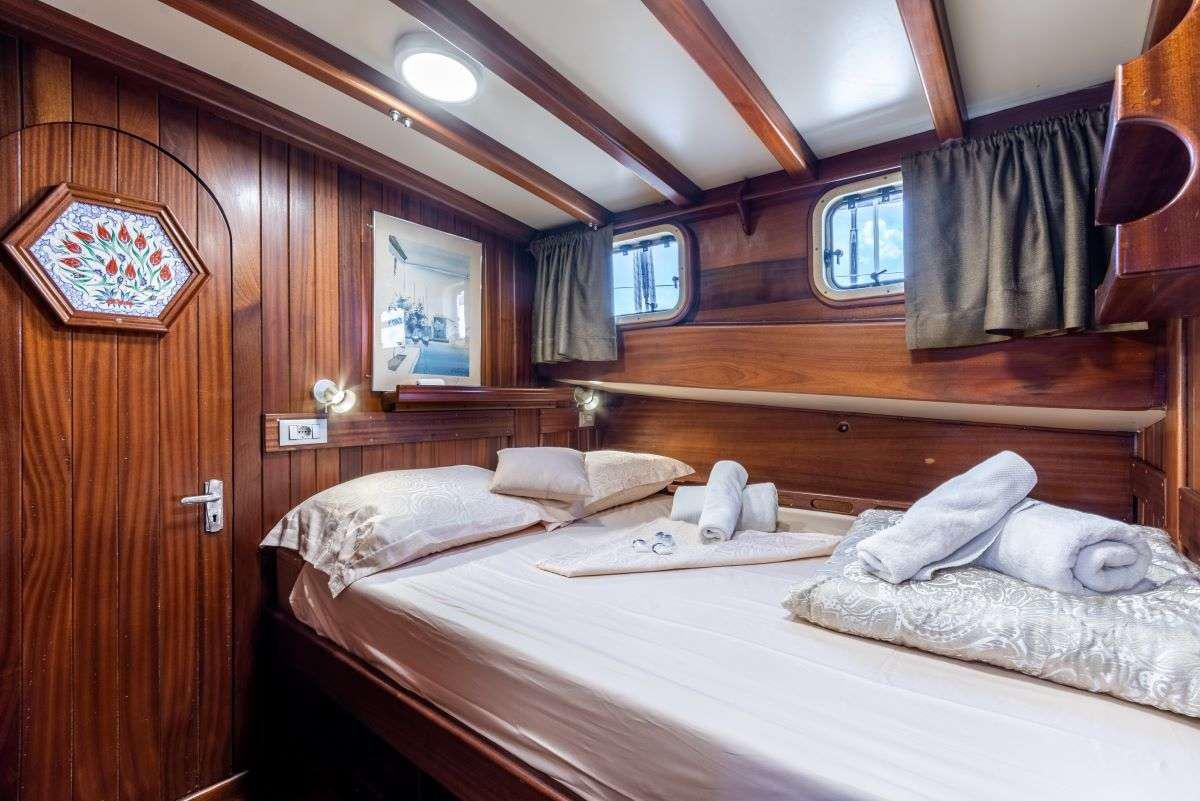 a room with a bed and a window aboard ANGELICA Yacht for Charter