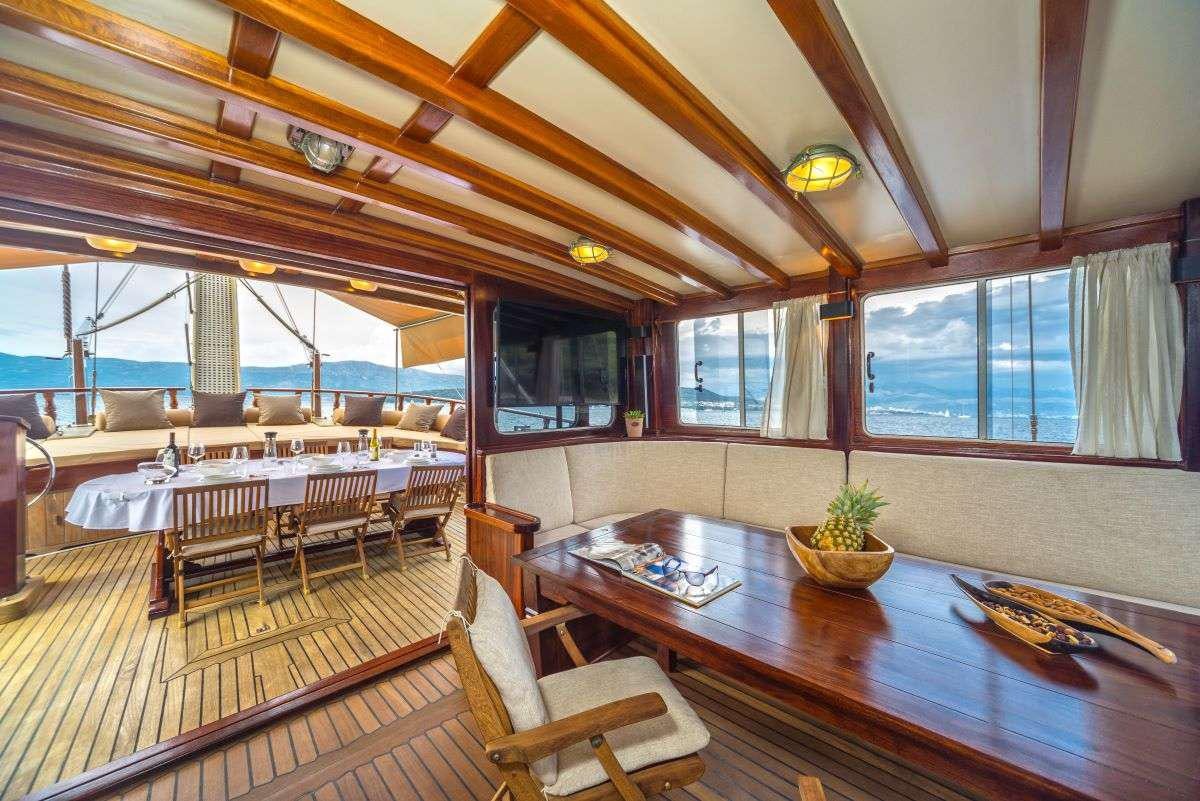 a large room with a table and chairs aboard ANGELICA Yacht for Charter
