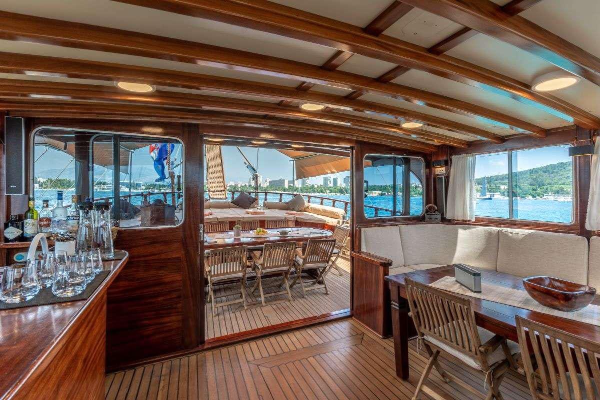 a room with a table and chairs aboard ANGELICA Yacht for Charter