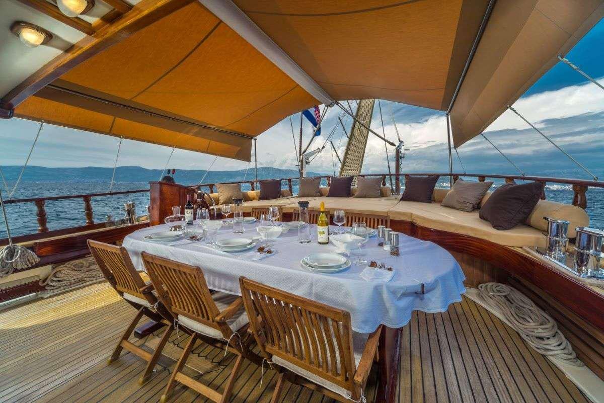 a table set for a meal on a boat aboard ANGELICA Yacht for Charter