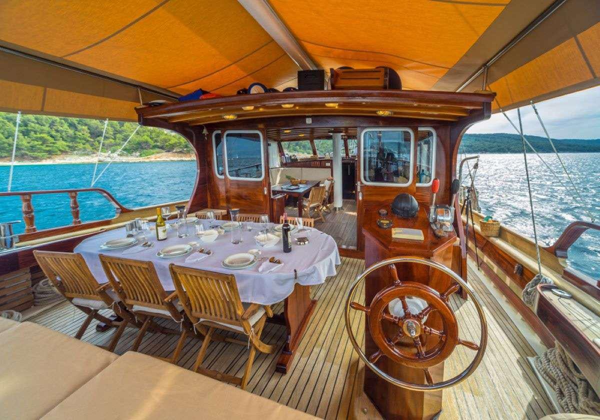 a boat with tables and chairs aboard ANGELICA Yacht for Charter