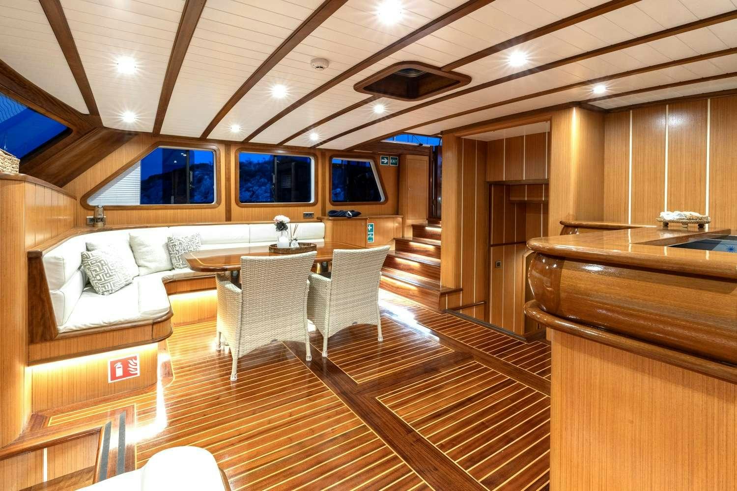 a room with a wood floor and a couch and a television aboard GOZDEM THE ONE Yacht for Charter