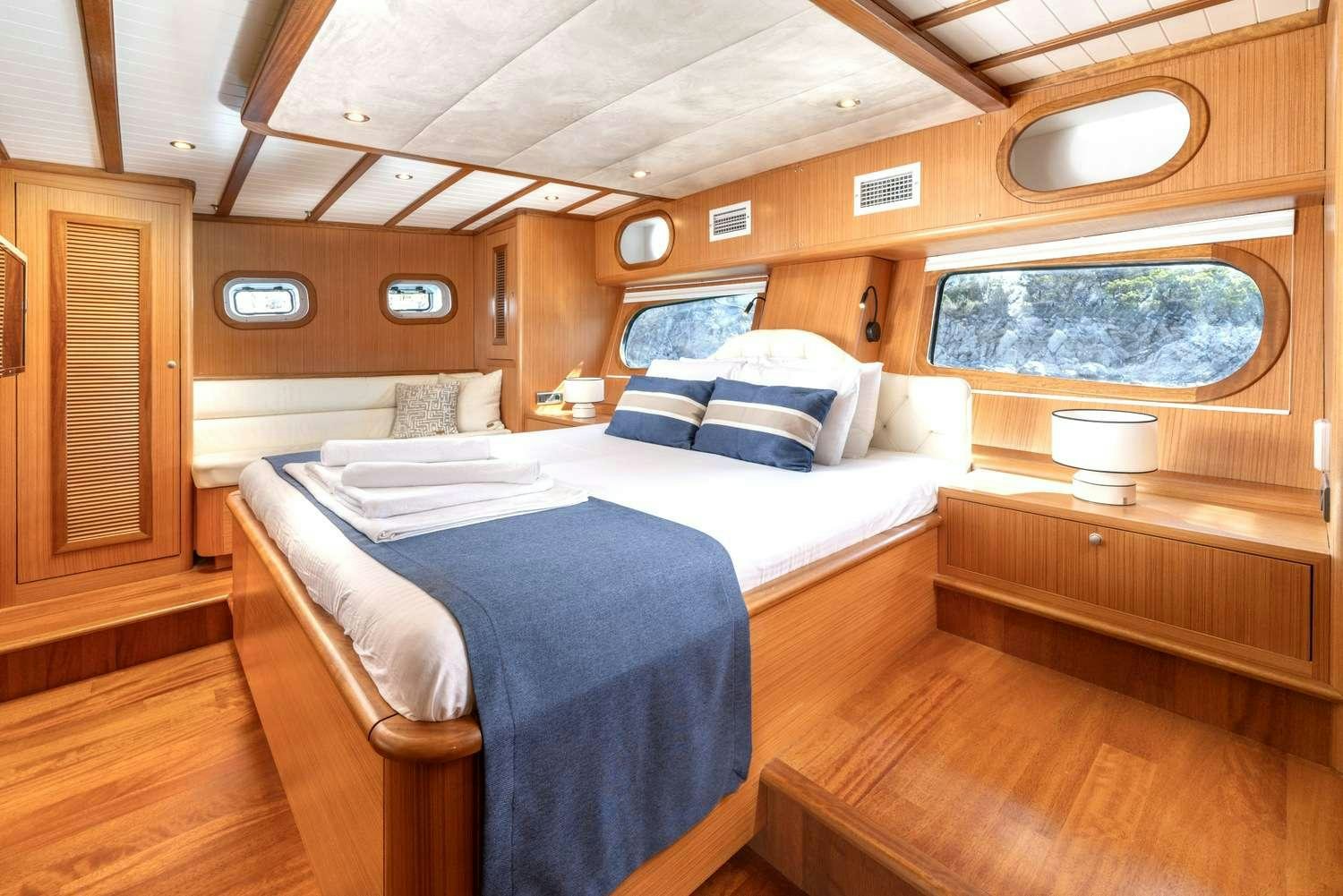 a room with a bed and a window aboard GOZDEM THE ONE Yacht for Charter
