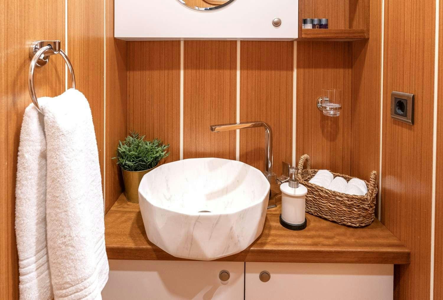 a bathroom with a sink and towels aboard GOZDEM THE ONE Yacht for Charter