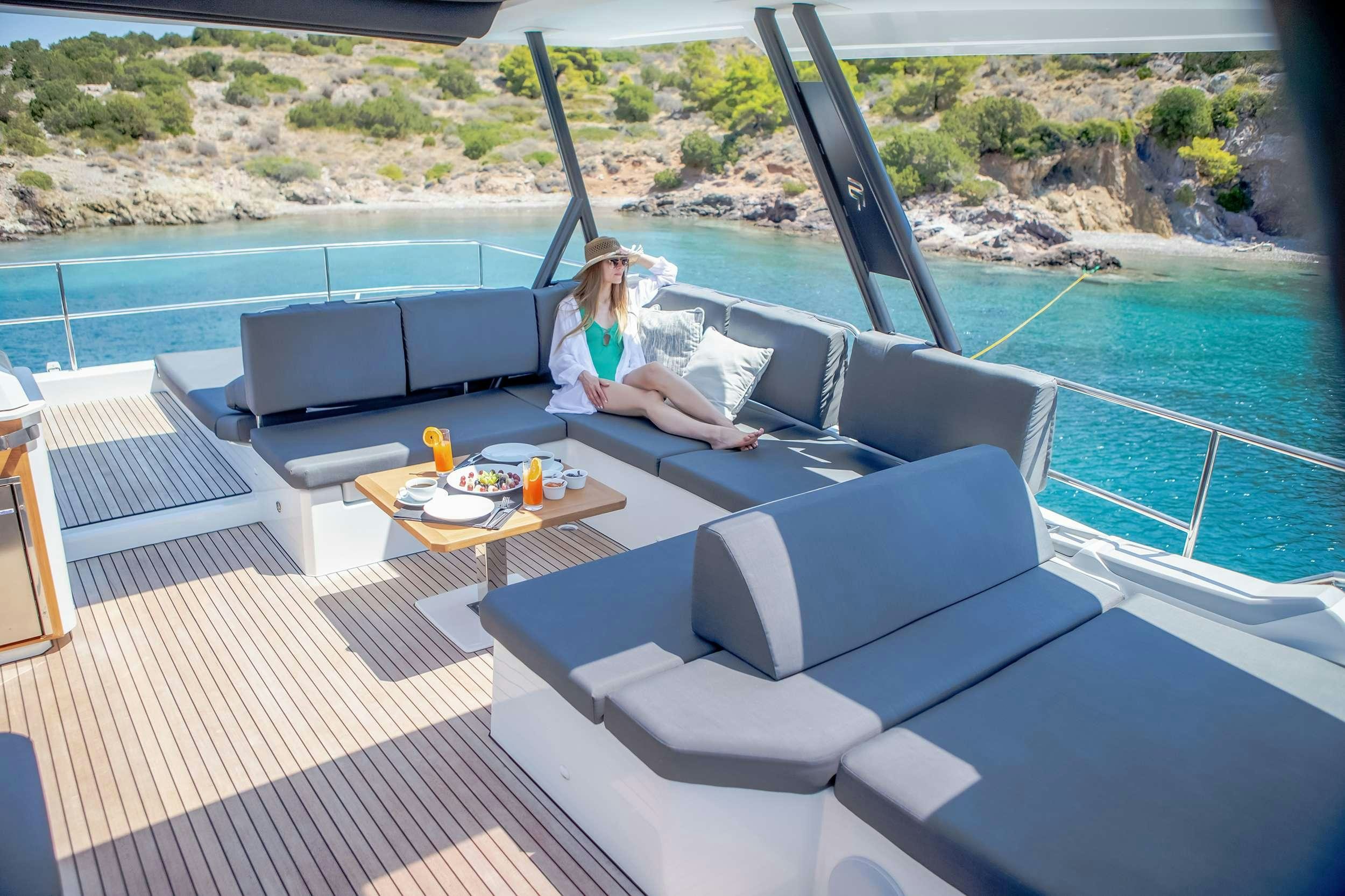 a person sitting on a couch aboard D2 Yacht for Charter