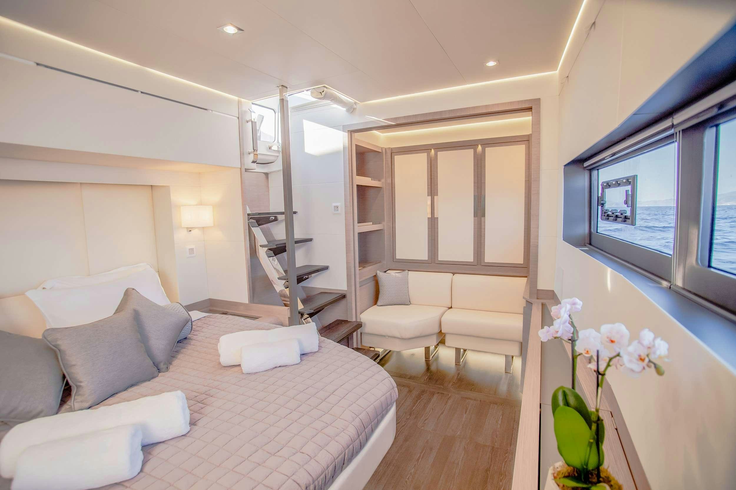a living room with a white couch and a television aboard D2 Yacht for Charter