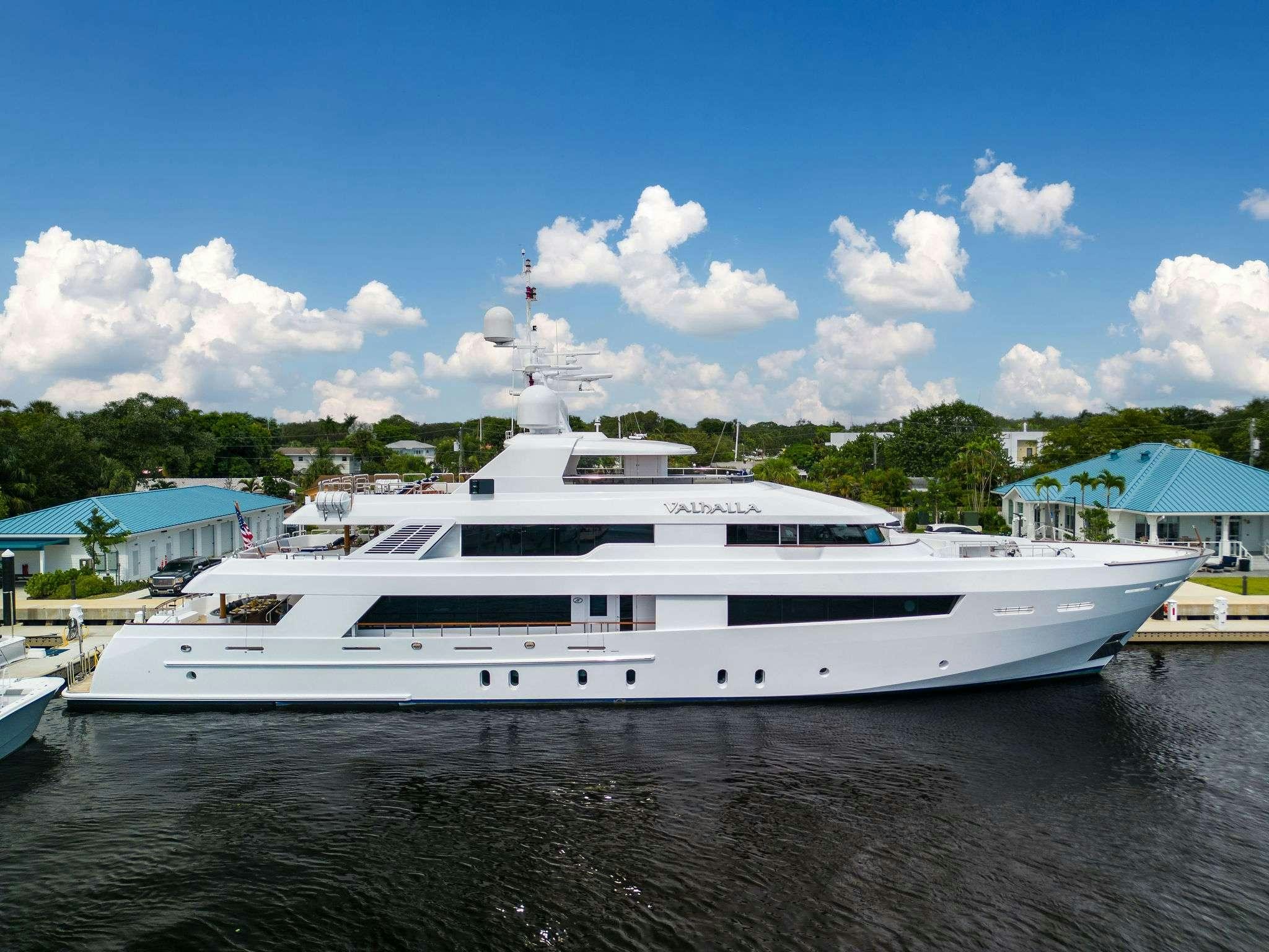 a white yacht in a harbor aboard VALHALLA Yacht for Charter