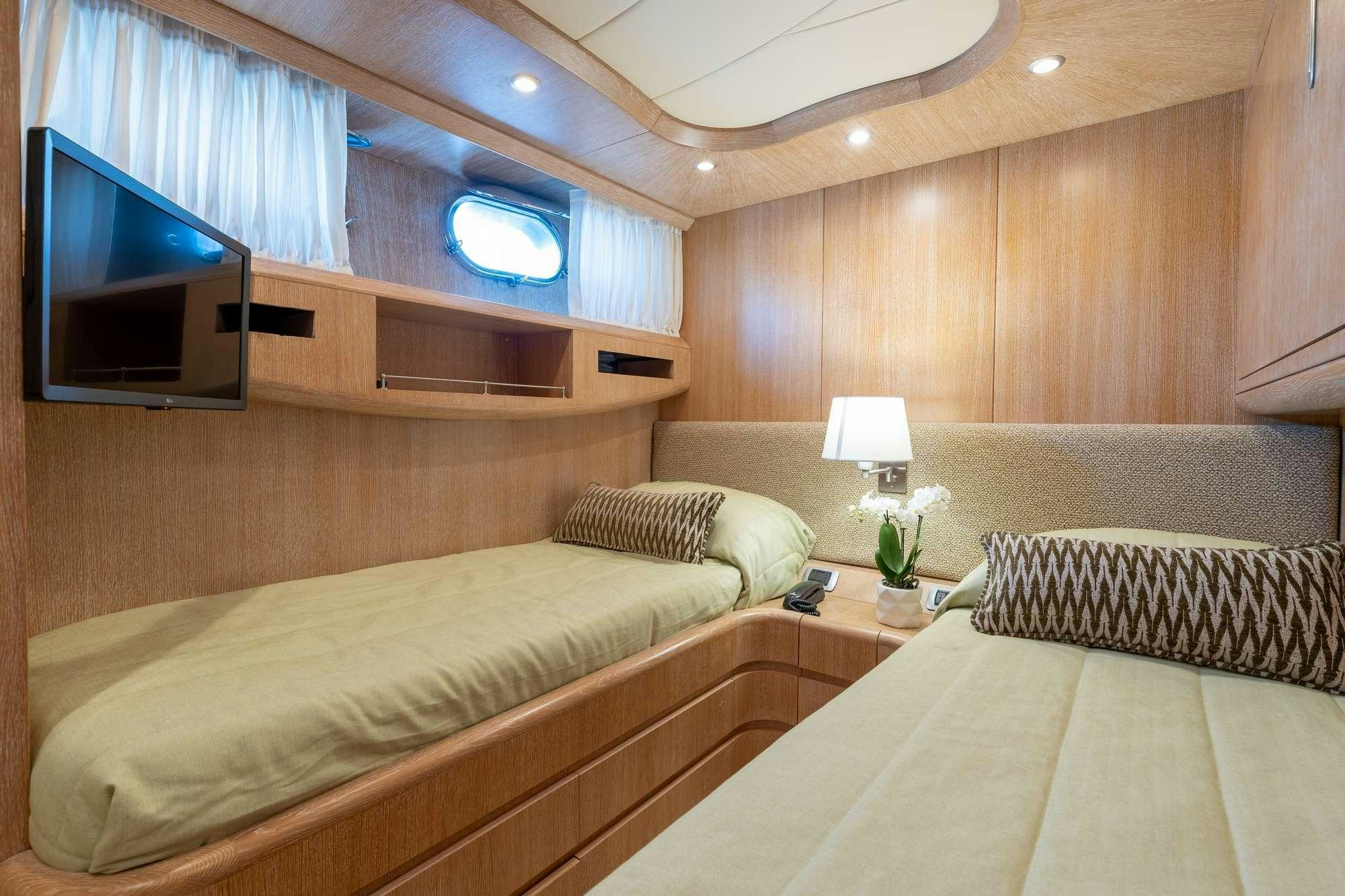 a room with a bed and a tv aboard COOKIE Yacht for Charter