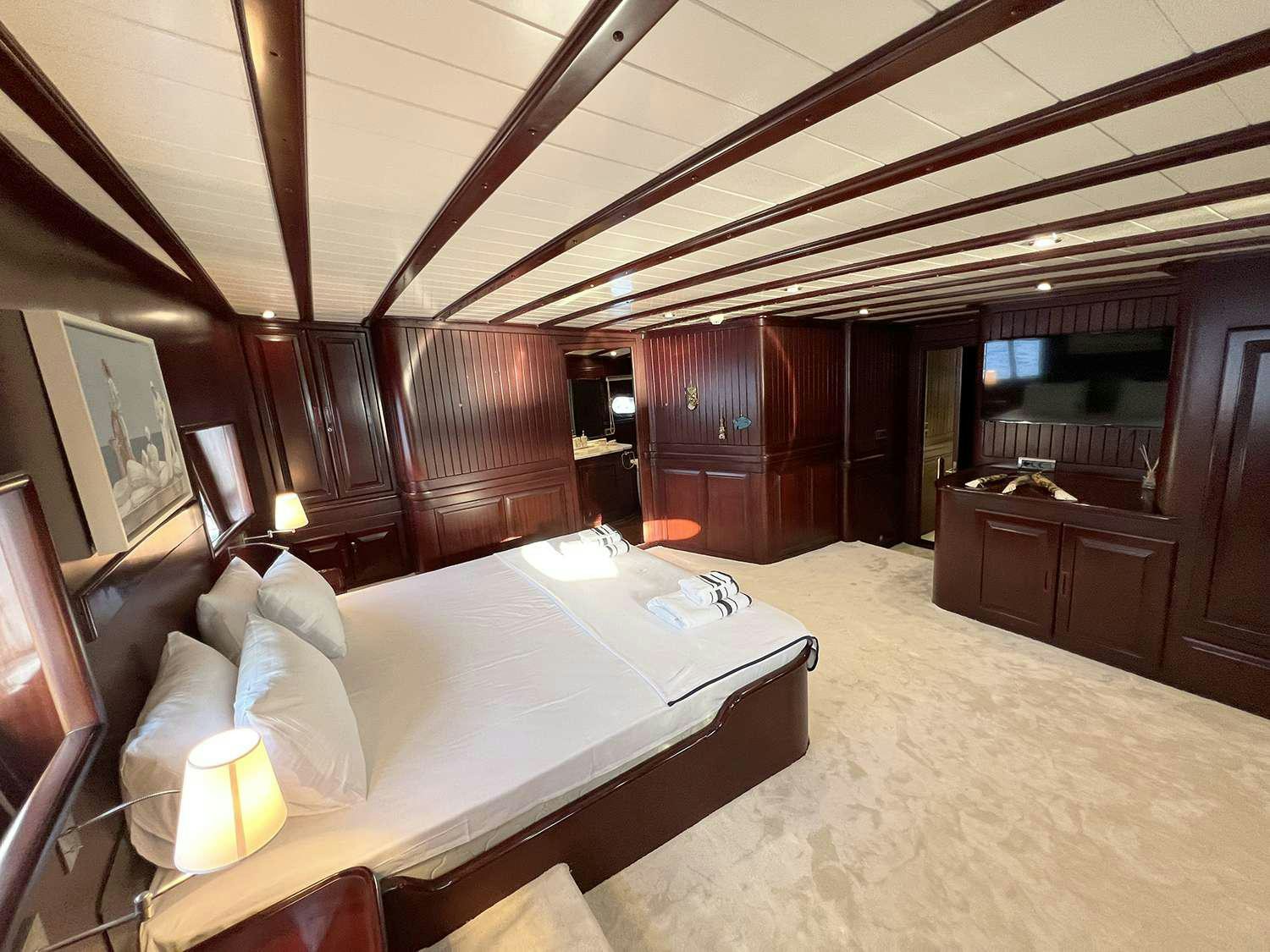 a large bed in a room aboard ALWAYS SMILE Yacht for Charter