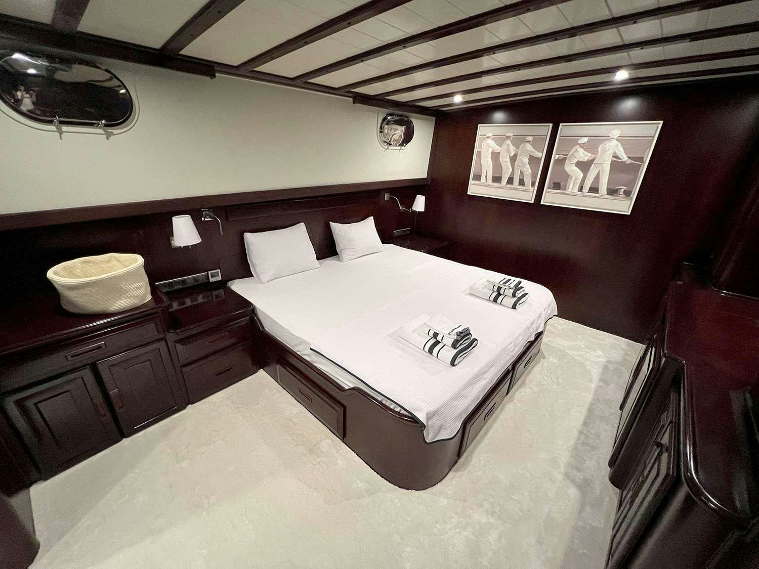 a bed in a room aboard ALWAYS SMILE Yacht for Charter