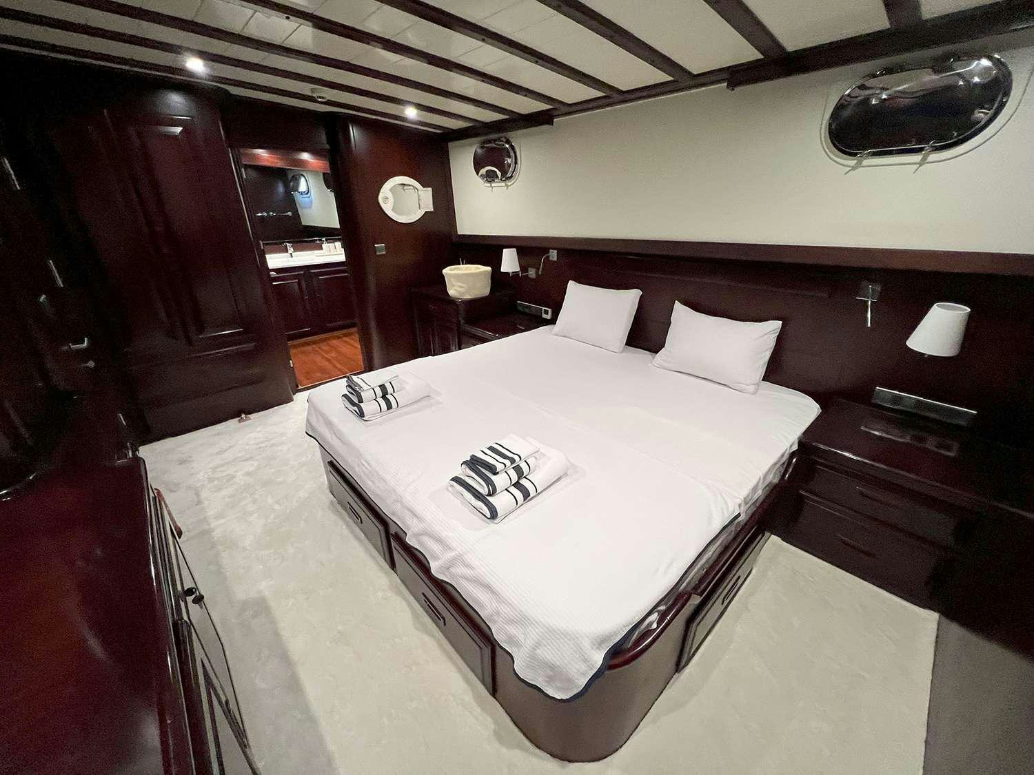 a bed in a room aboard ALWAYS SMILE Yacht for Charter