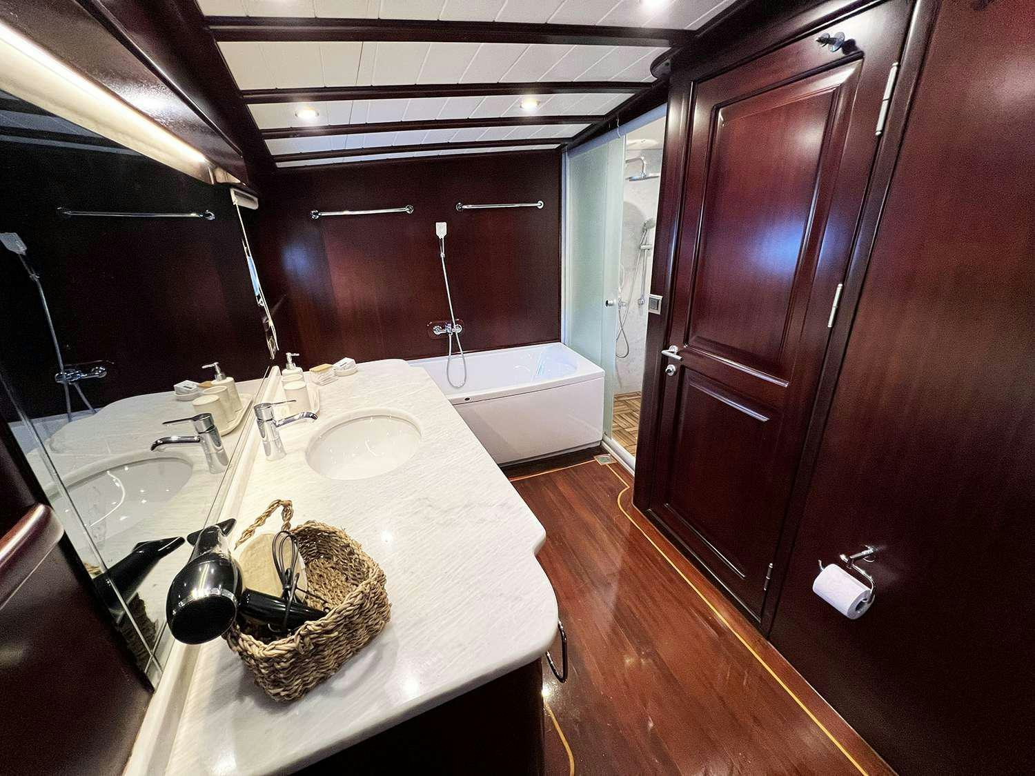 a bathroom with a sink and a bathtub aboard ALWAYS SMILE Yacht for Charter