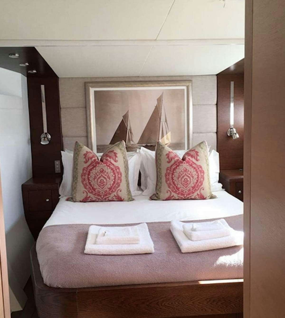 a bed with pillows aboard HQ2 Yacht for Charter