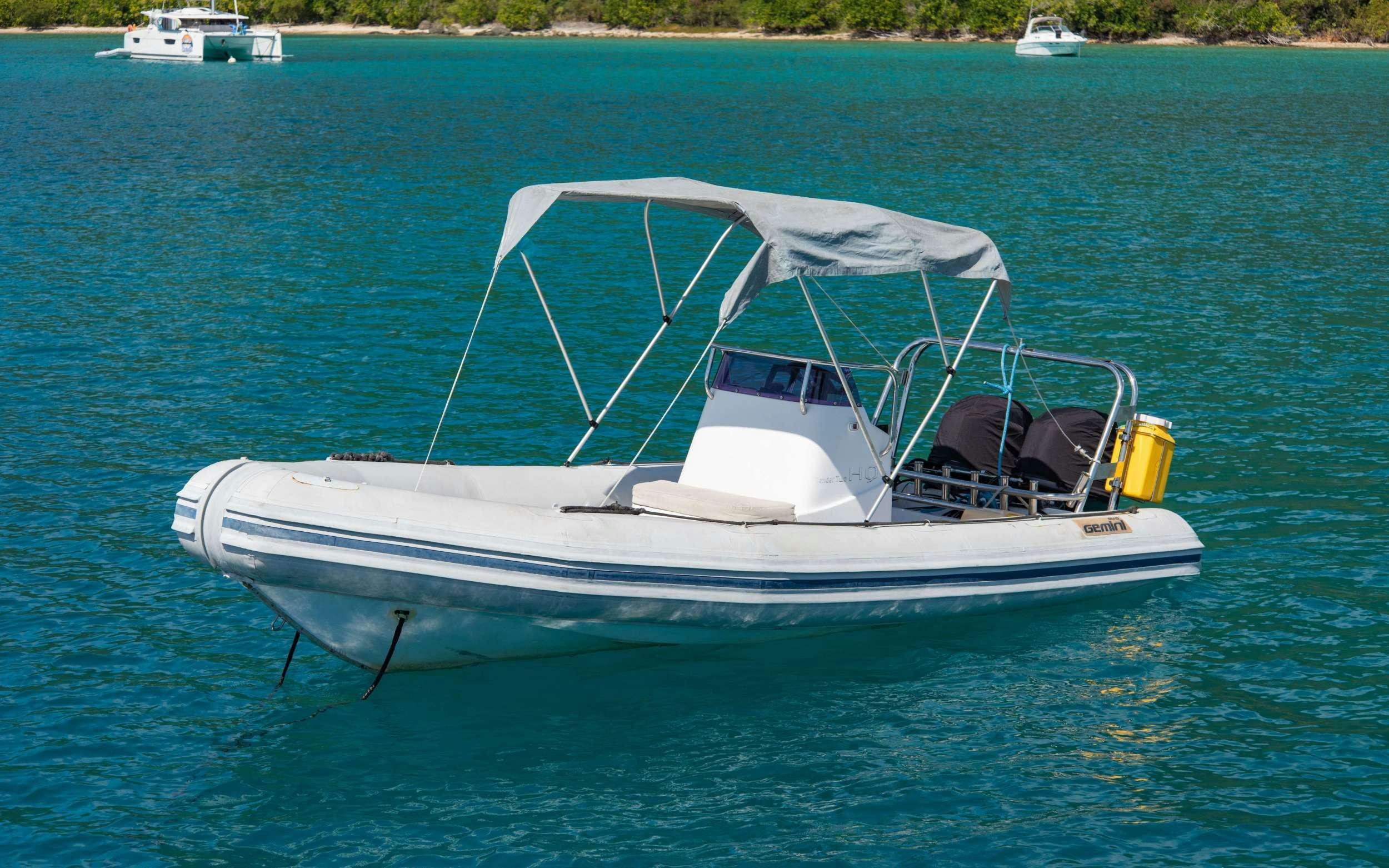a white boat in the water aboard HQ2 Yacht for Charter