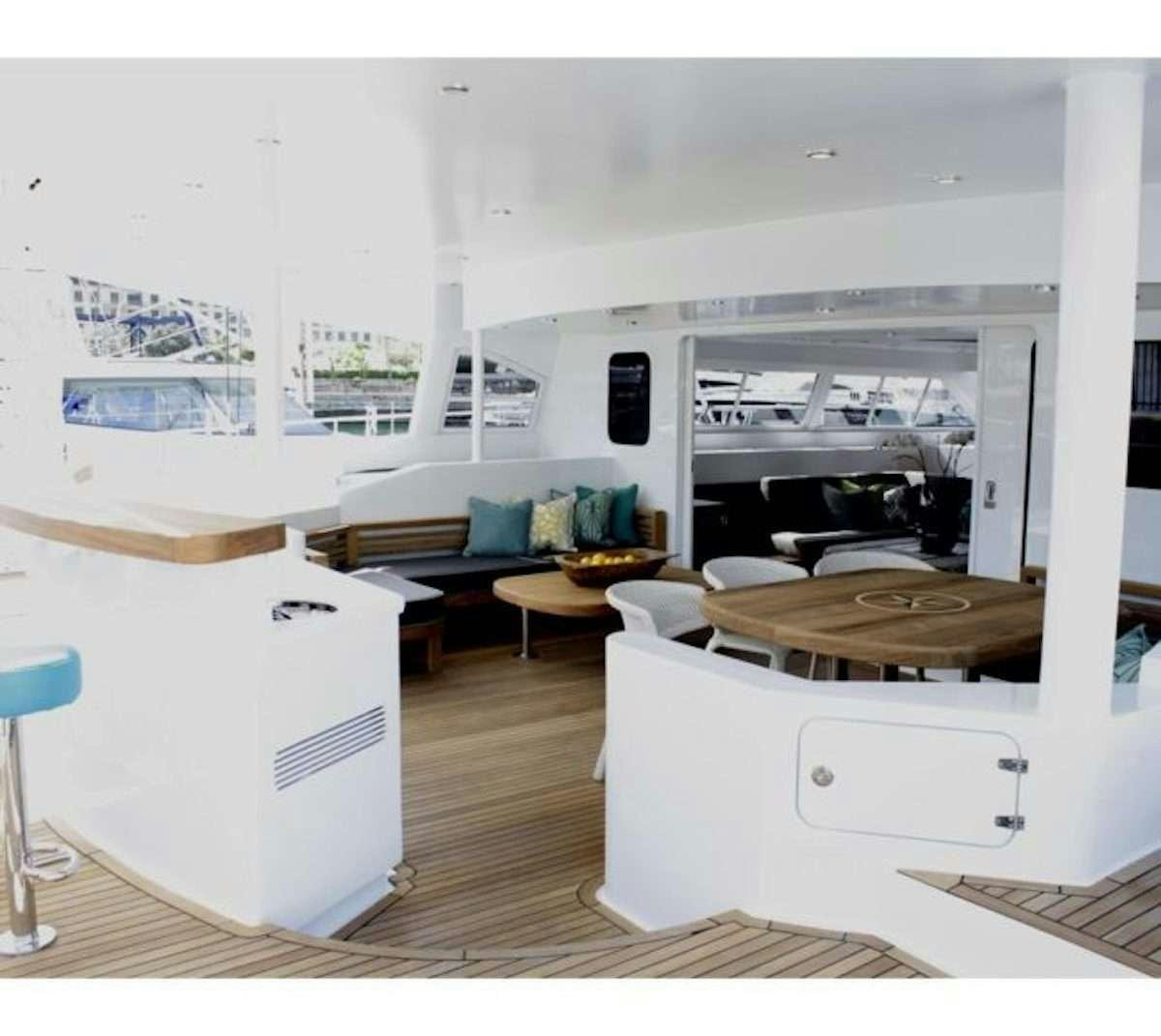 a room with a couch and a table aboard HQ2 Yacht for Charter