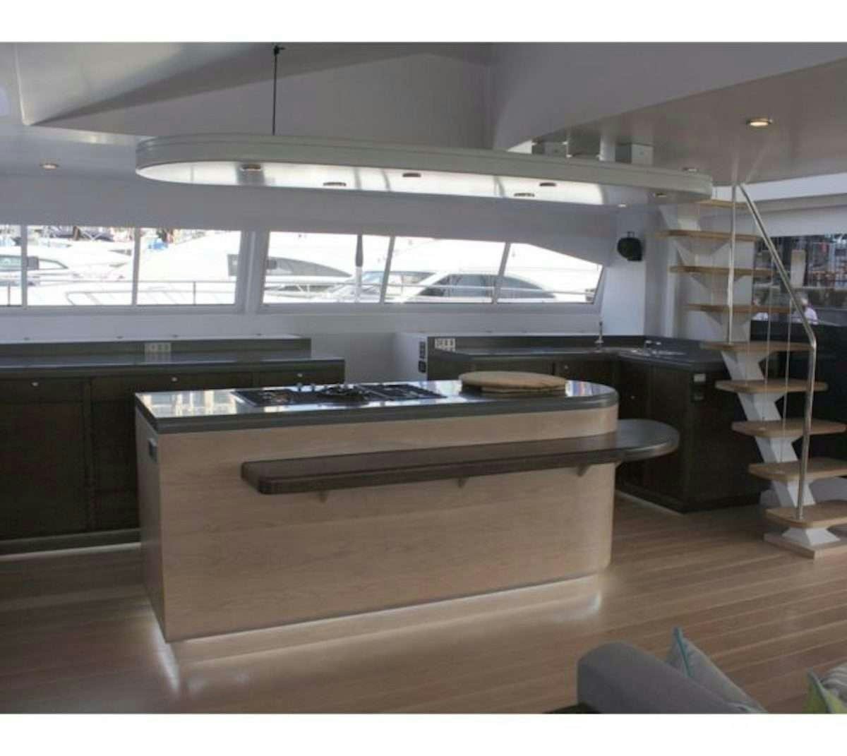 a room with a desk and a shelf with books on it aboard HQ2 Yacht for Charter