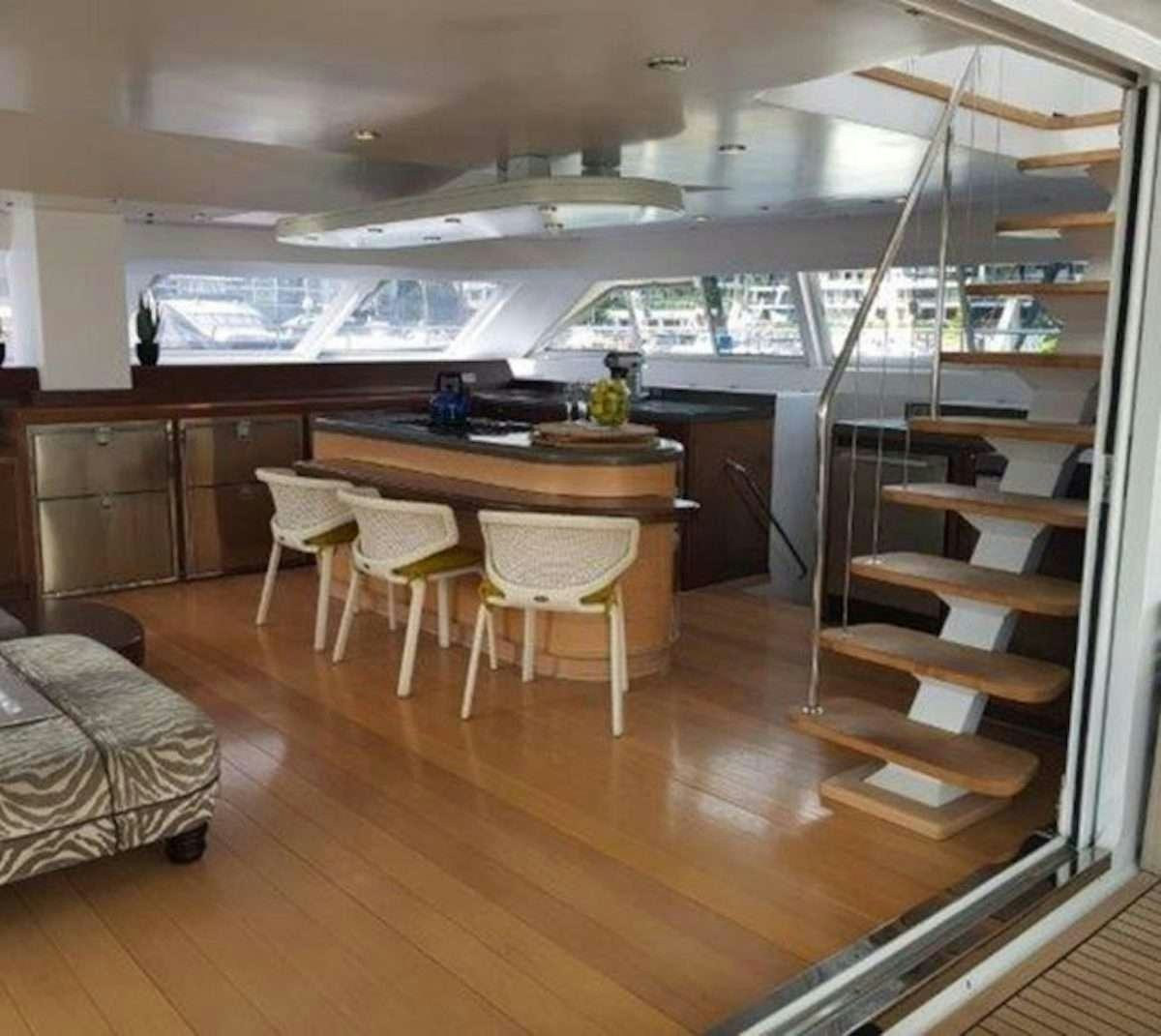 a room with a table and chairs aboard HQ2 Yacht for Charter