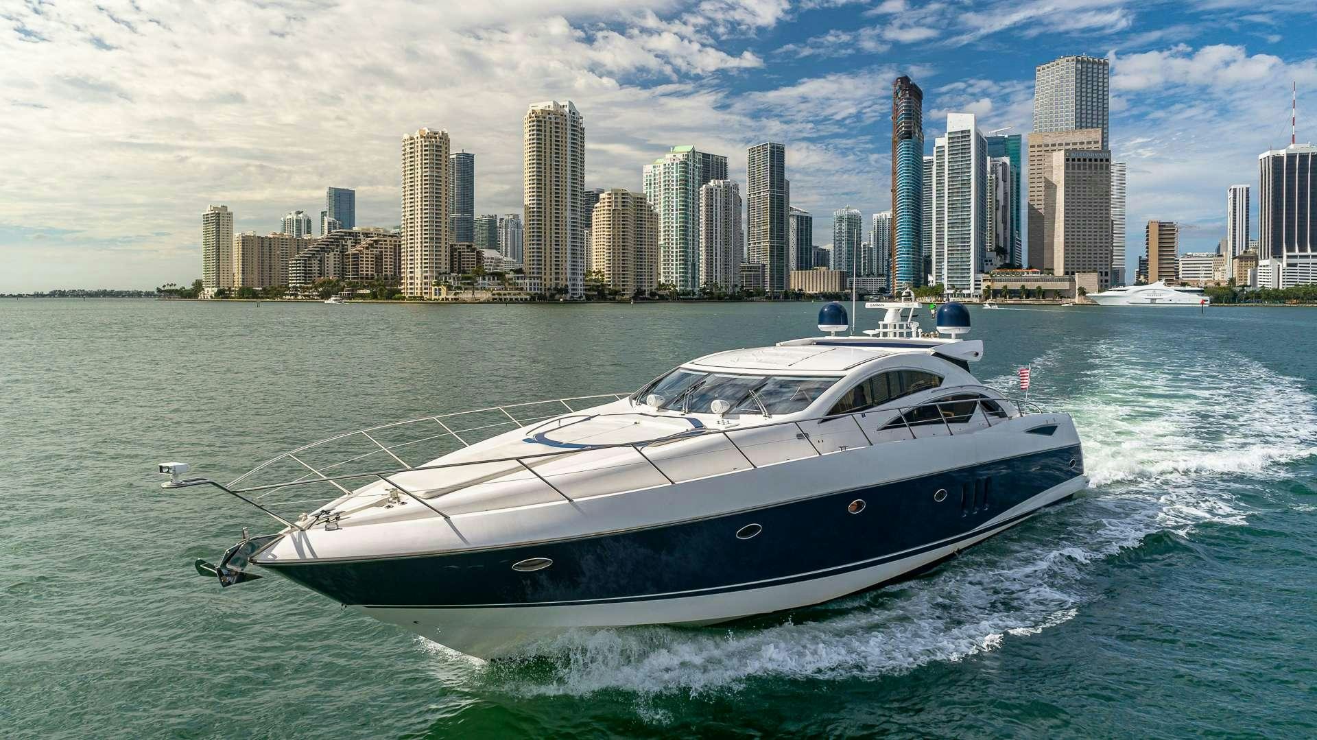 a white yacht in the water aboard AQUAHOLIC Yacht for Charter