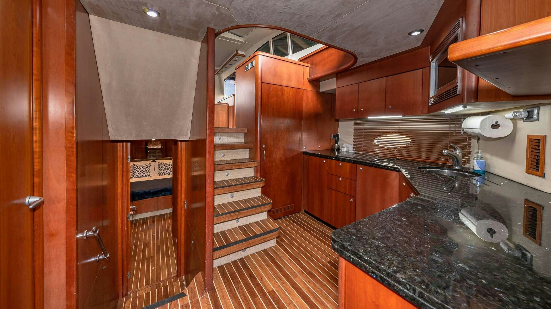 a kitchen with wooden cabinets aboard AQUAHOLIC Yacht for Charter
