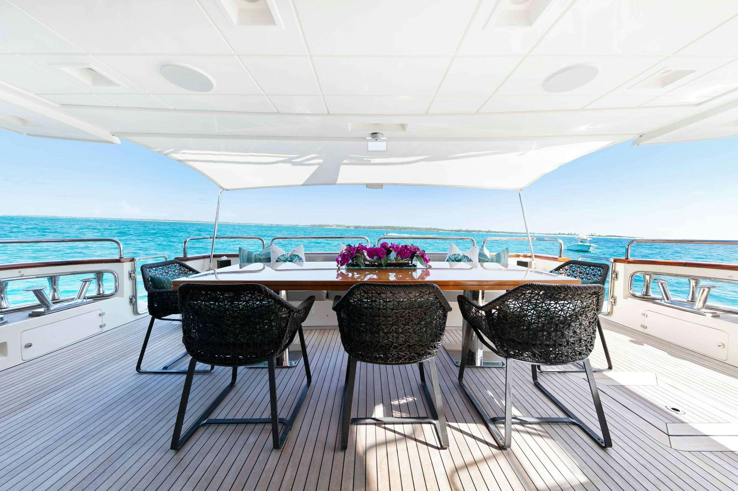 a table and chairs on a boat aboard CAMY ED Yacht for Charter