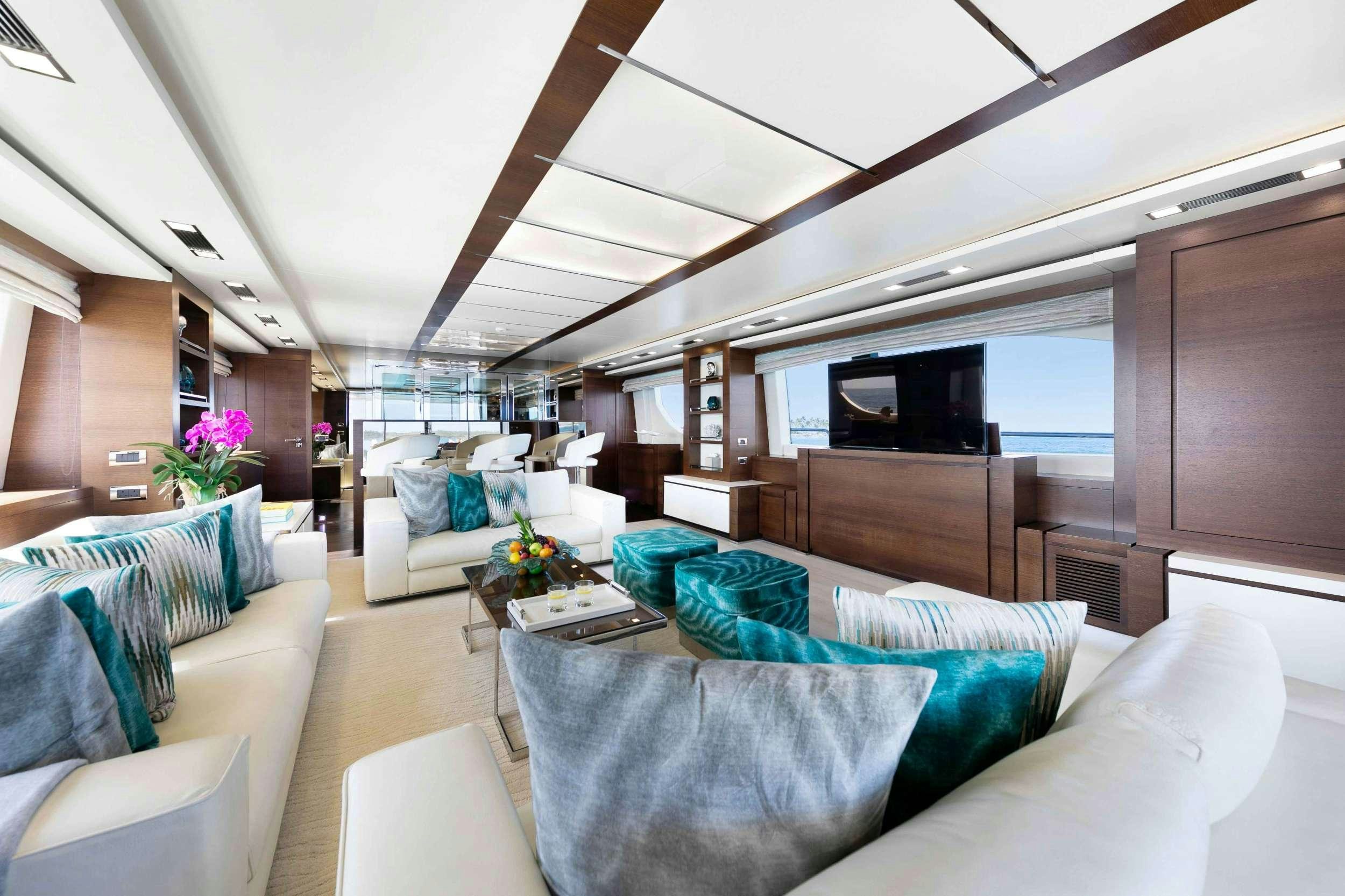 a living room with a couch and a television aboard CAMY ED Yacht for Charter