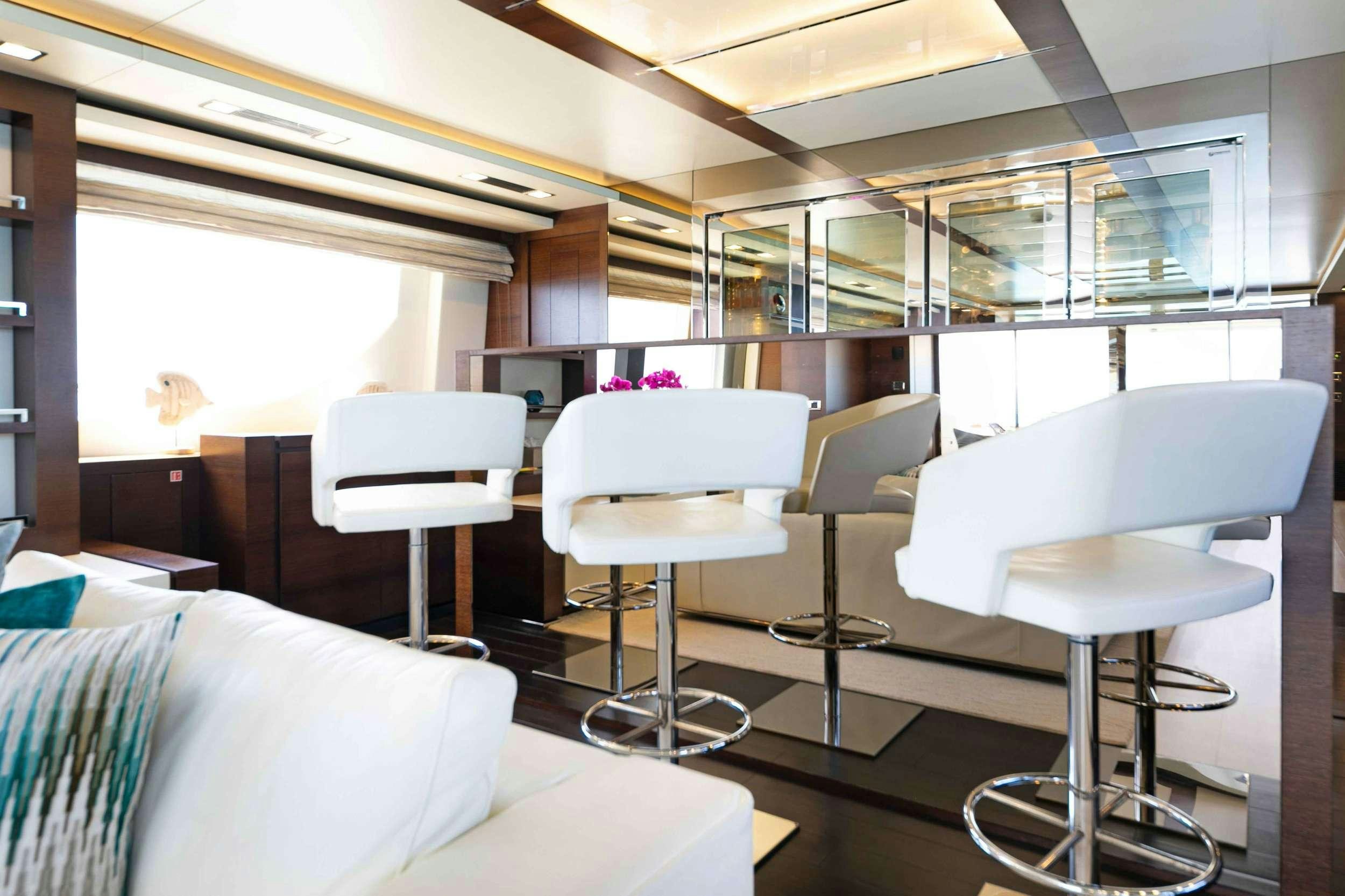 a room with chairs and tables aboard CAMY ED Yacht for Charter