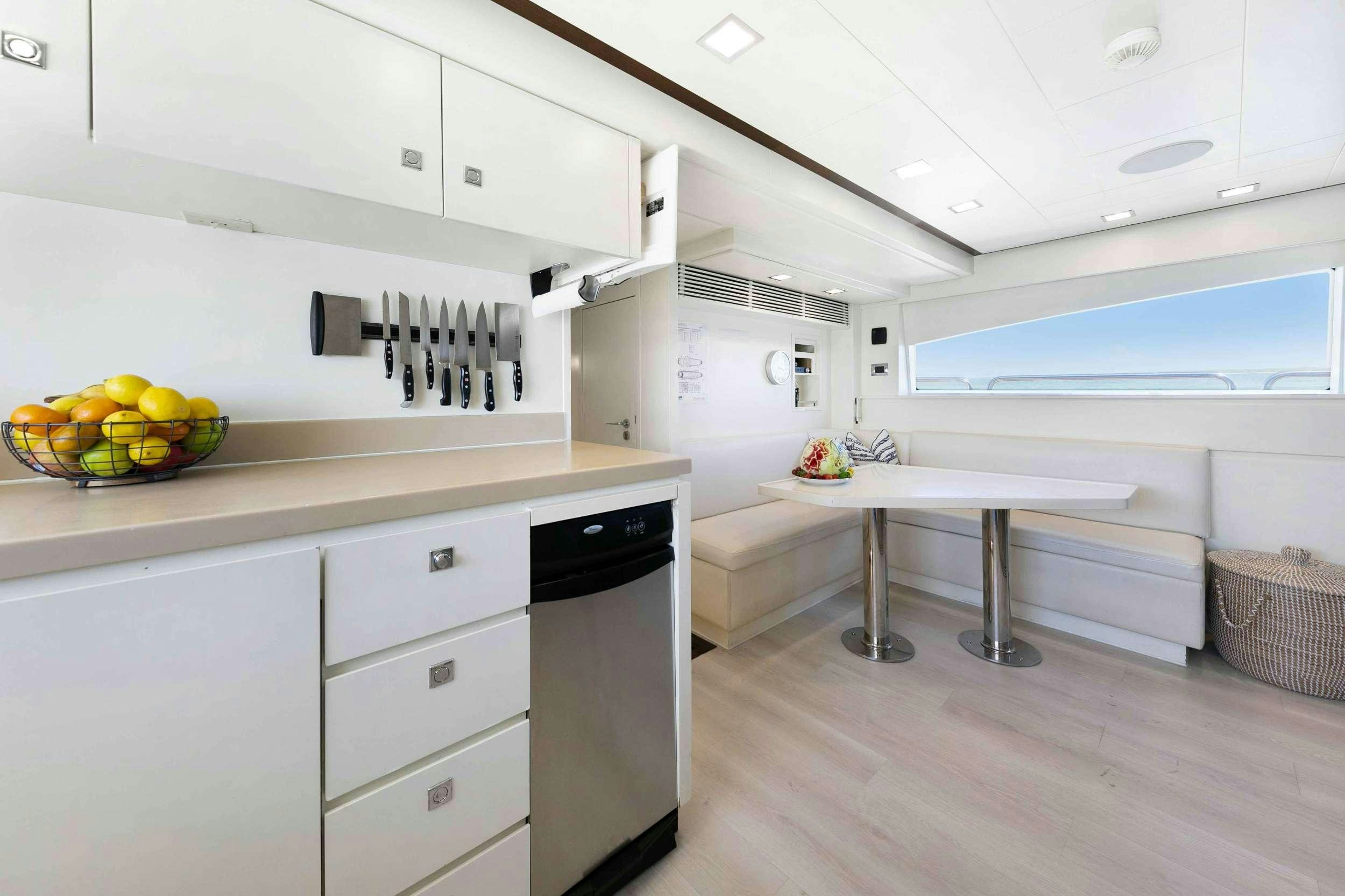 a kitchen with white cabinets aboard CAMY ED Yacht for Charter