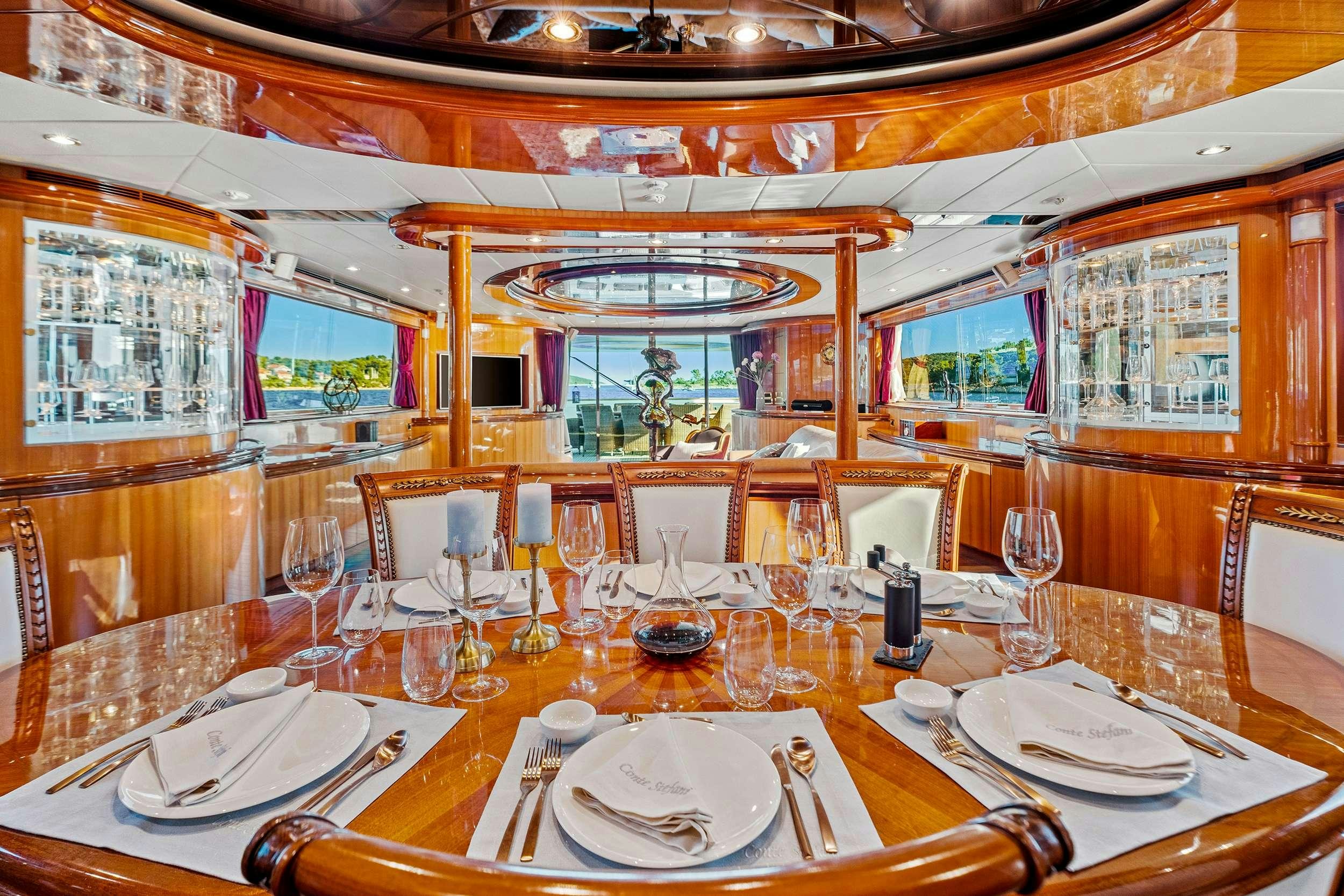 a table set with place settings aboard CONTE STEFANI Yacht for Charter