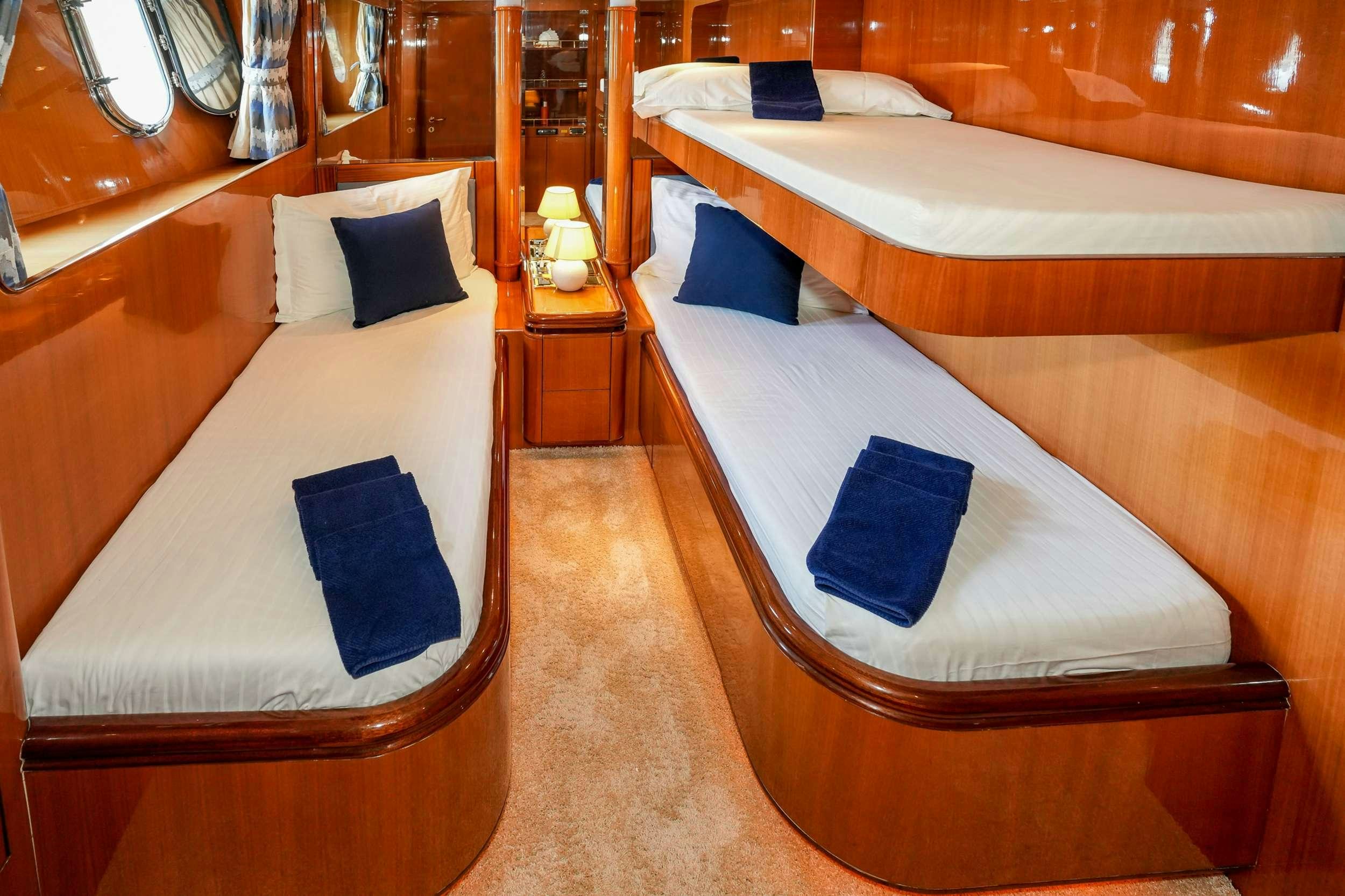 a room with beds and a bed aboard CONTE STEFANI Yacht for Charter